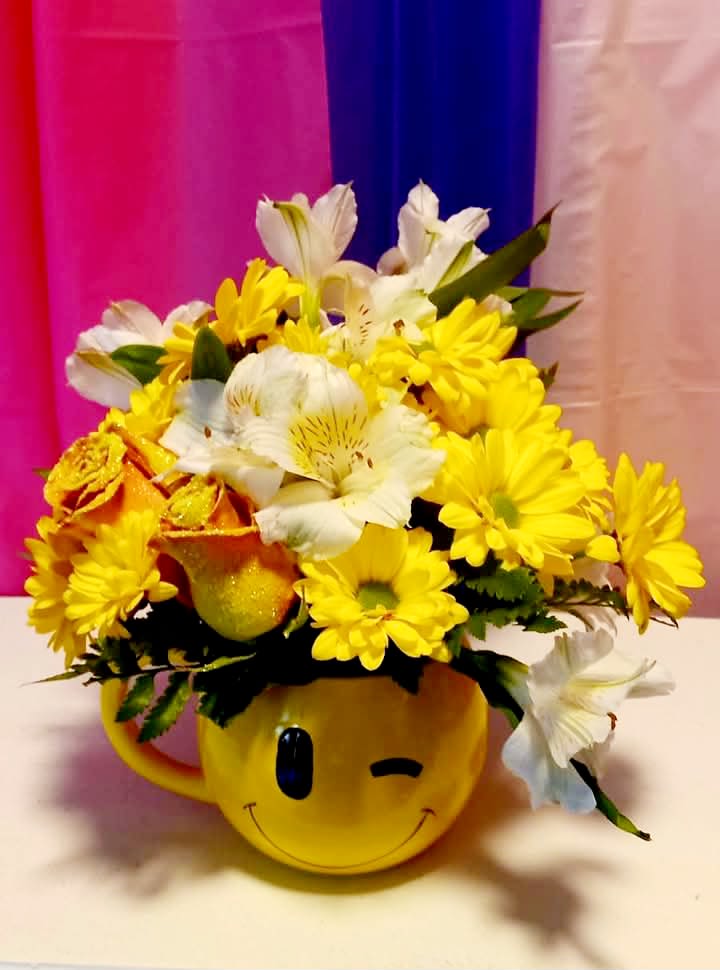 Oh Happy Day! - This arrangement is very pretty in yellows and whites including roses, daisies, and alstroemeria and the container is a smiley face mug! Super cute and ready to make some ones day great!