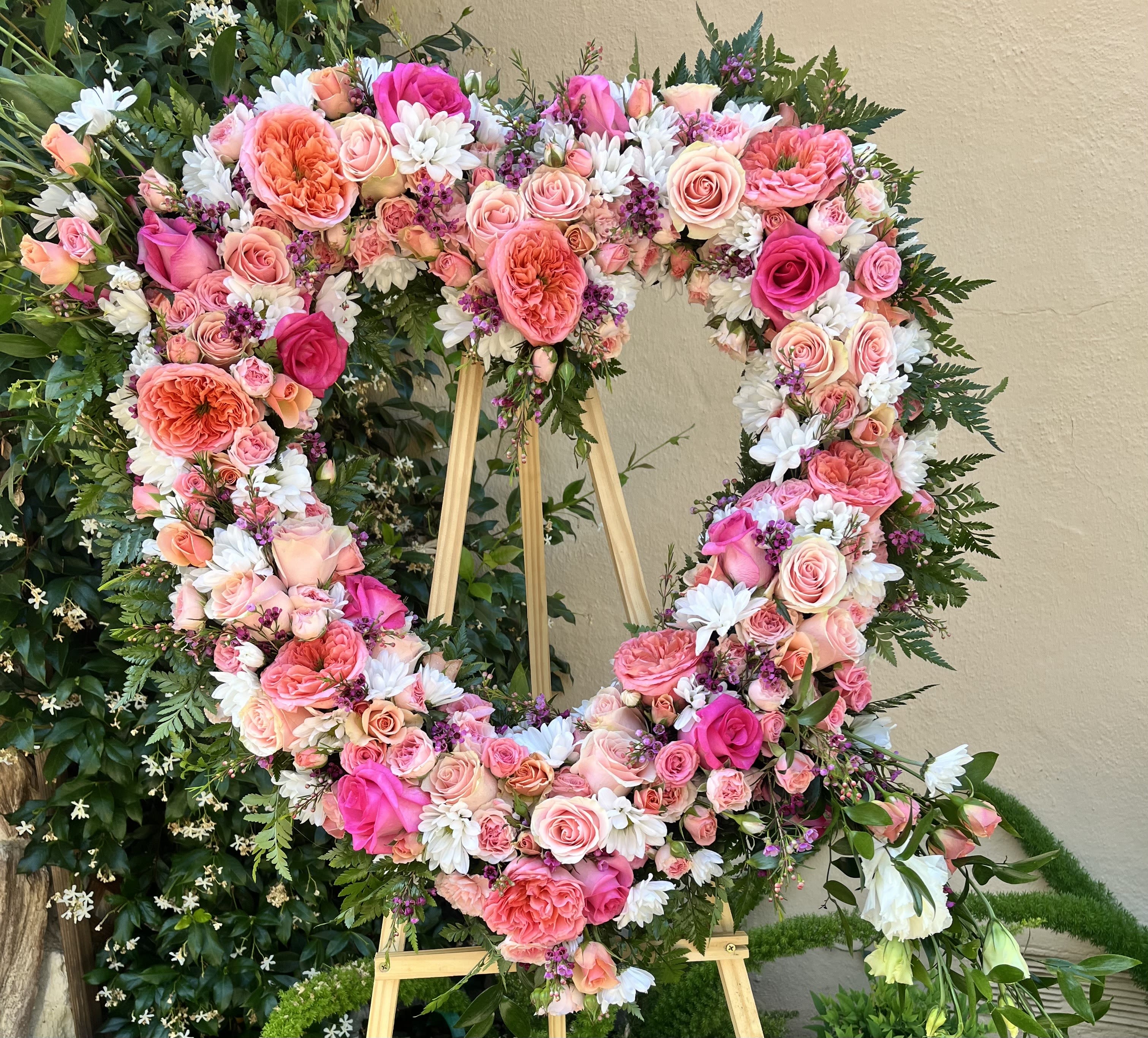 With Heartfelt Love - This Heart Shaped, Standing Spray is a bright and uplifting tribute for a colorful remembrance.  All Sympathy Standing Sprays are custom made to order. Any specifics can be discussed further by phone,  if not noted in special instruction area. Kindly call to discuss any specifications or concerns. (707)479-1606