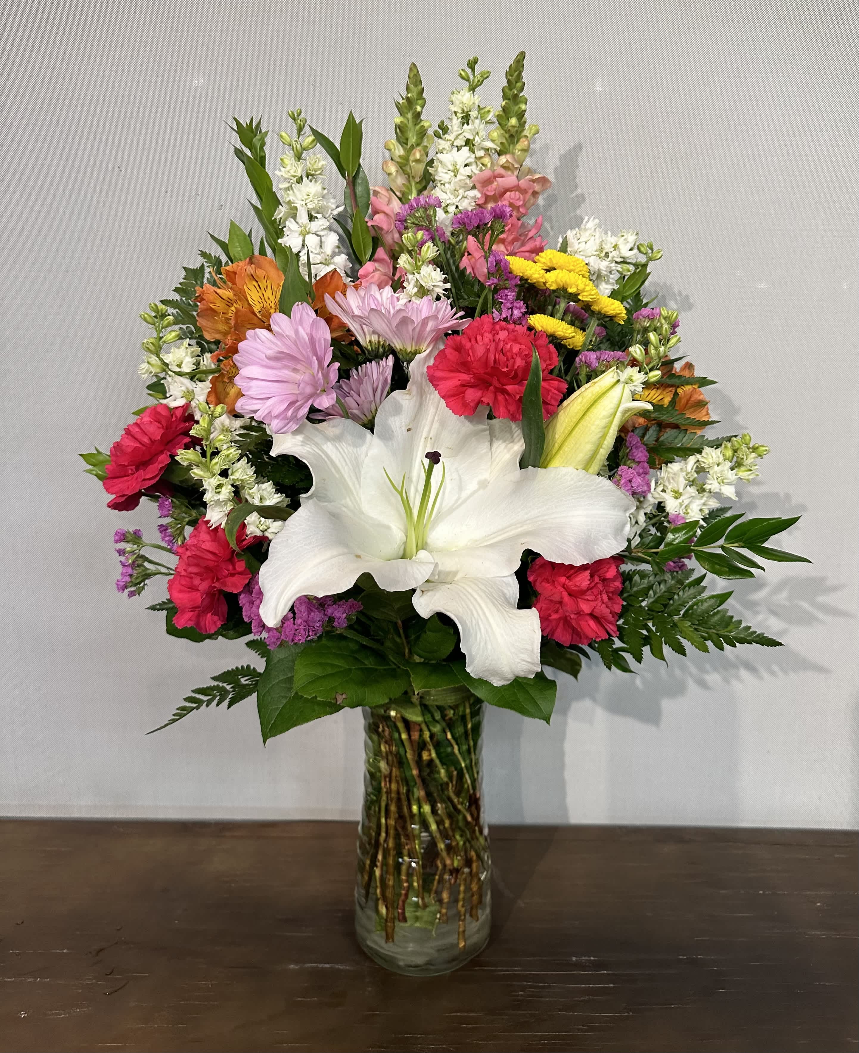 Designers Choice Vase Mix - Mixture of the freshest florals to accommodate to any occasion. Give us the occasion and our designers will pick out the best florals to fix the occasion. Arrangement will be a mixture of our season florals. This is the perfect arrangement to let our designers create the best match for your occasion. 