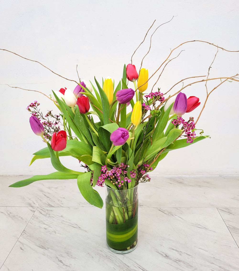 Simply Tulips - Mixed color tulips arranged in a vase.  - Beautiful mixed colorful Tulips arranged in a vase. For the tulip lover in your life, Simply Tulips features (20) fabulous, fun, fresh colorful Tulips with lush greens and accents. Order today, from A Beautiful California Florist, Long Beach CA favorite five 5 star flower shop offering same day flower delivery.
