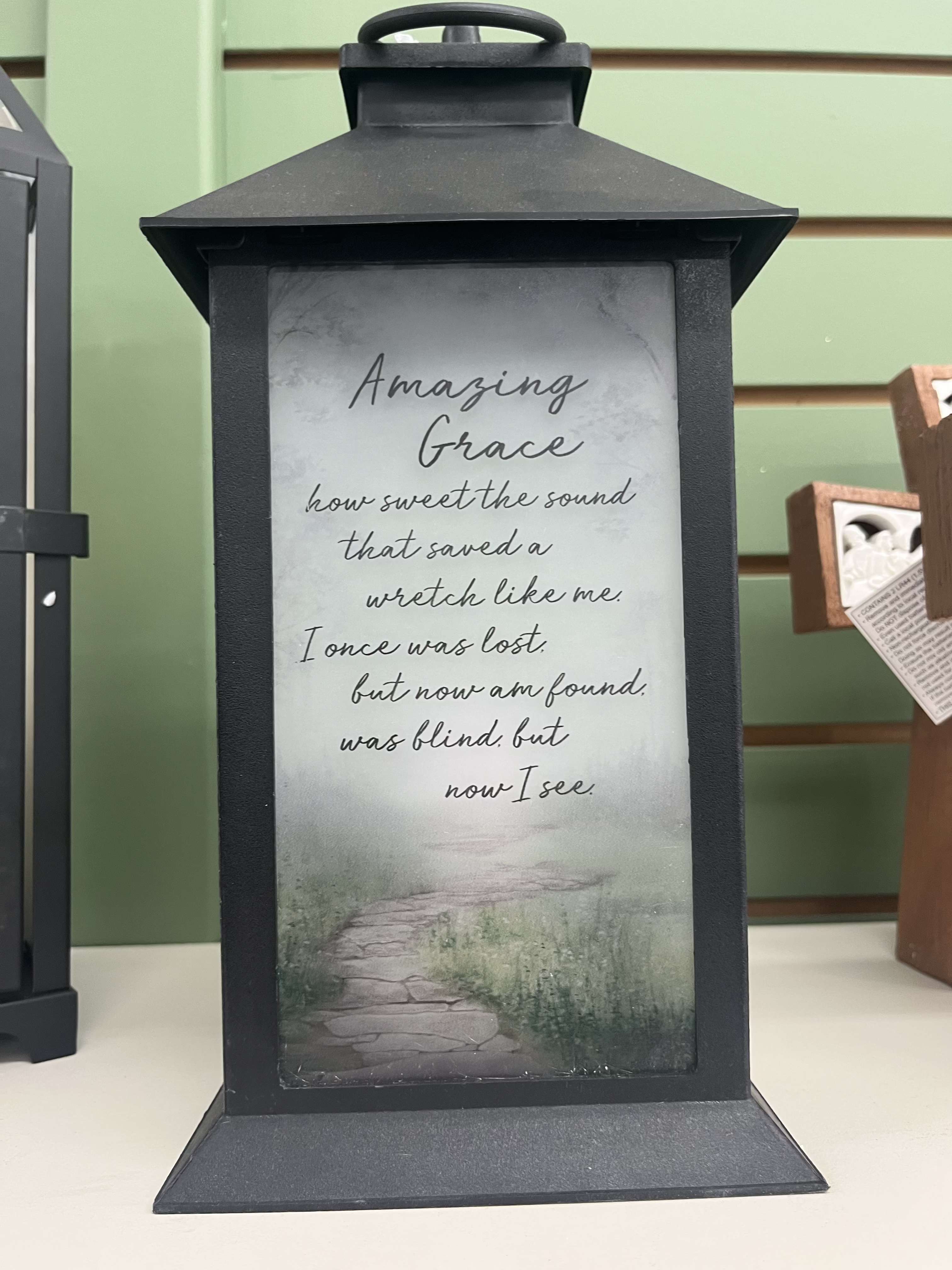 Amazing Grace Lantern Amazing Grace Lantern - This light up lantern has frosted glass and features a pathway scene and the saying" Amazing Grace how sweet the sound that saved a wretch like me. I once was lost but now am found, was blind, but now I see.".