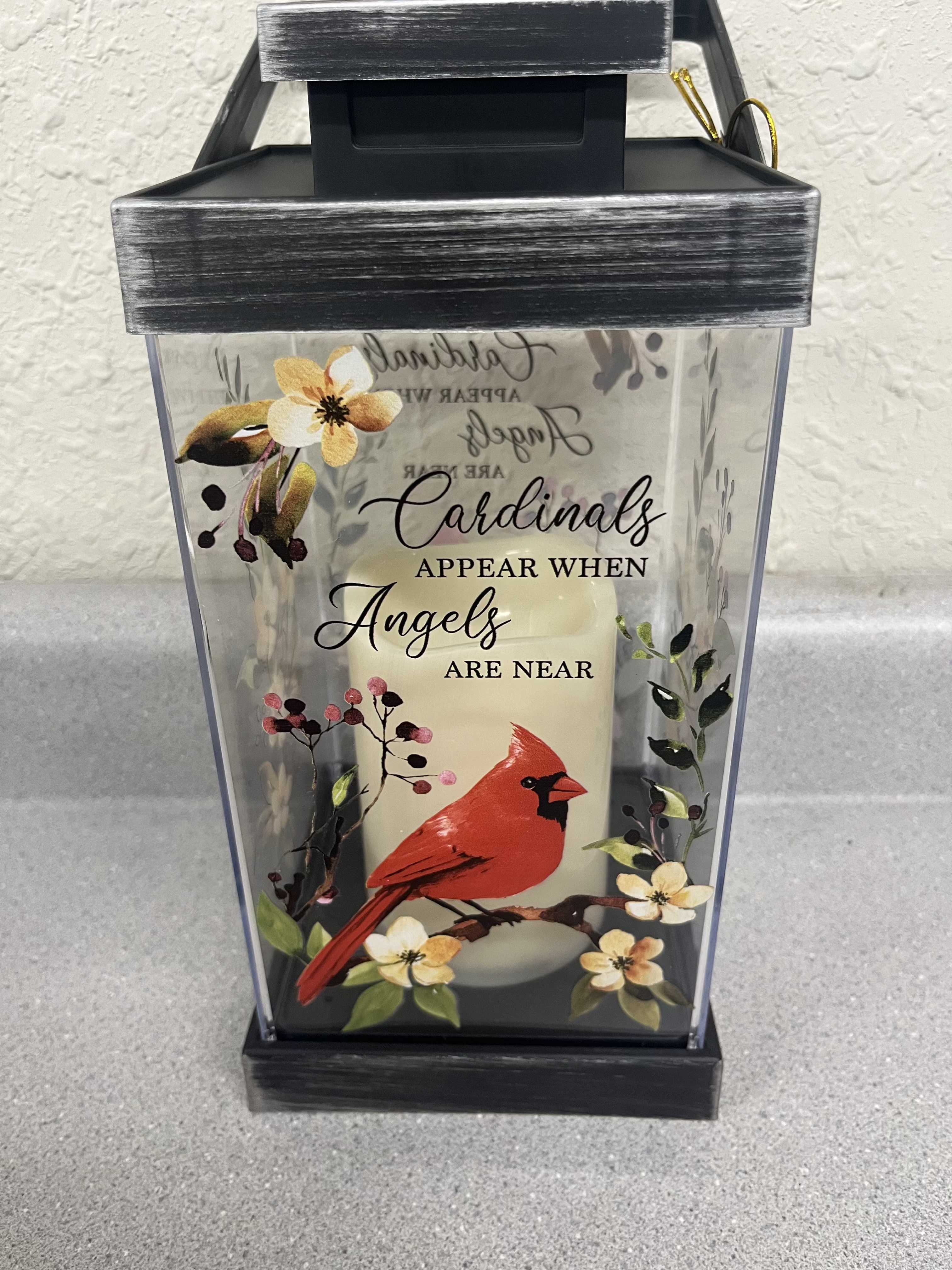 Cardinal Lantern Cardinal Lantern - This light up lantern features a floral scene with a cardinal and the saying, "Cardinals appear when angles are near". The saying and scene are on both the front and the back side.