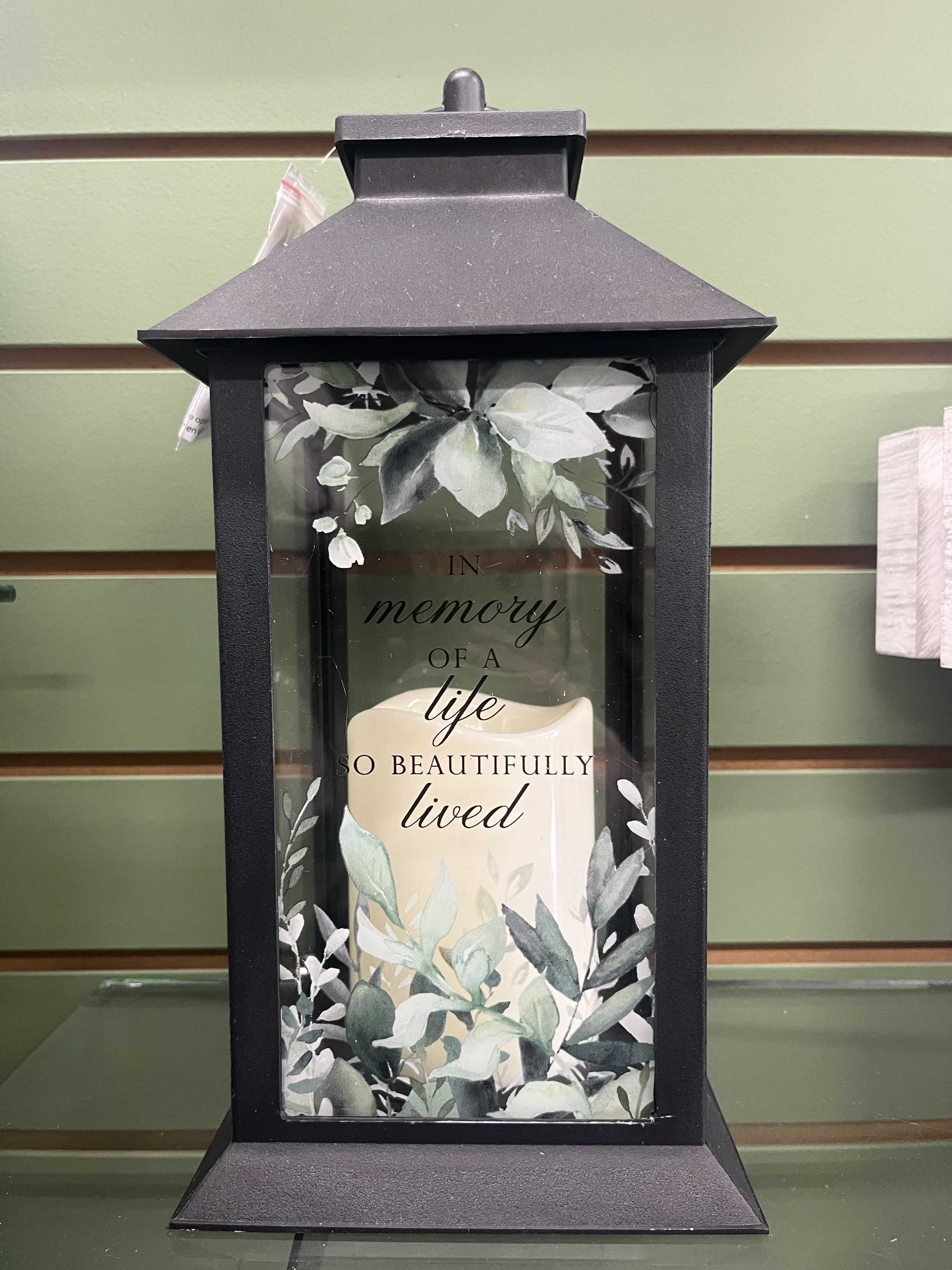 In Memory Of A Life So Beautifully Lived Lantern In Memory Of A Life So Beautifully Lived Lantern - Light up lantern with greenery picture and "In Memory Of A Life So Beautifully Lived" saying.