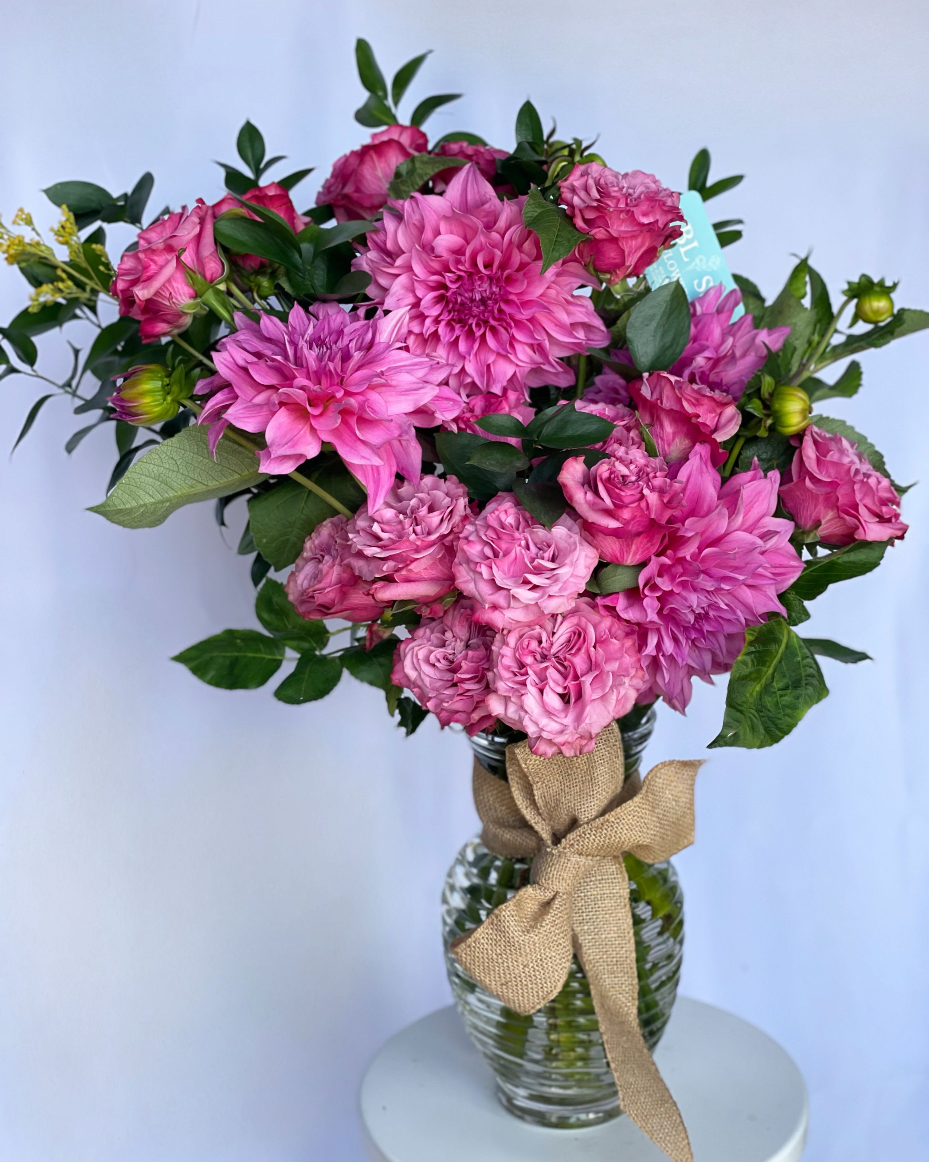 The pink affair  - Experience the allure of this stunning pink arrangement, featuring luxurious pink roses and majestic pink dahlias.Perfect for special occasions or adding a touch of sophistication to any space, this unique floral masterpiece showcases the beauty of vibrant pinks and lush textures. 