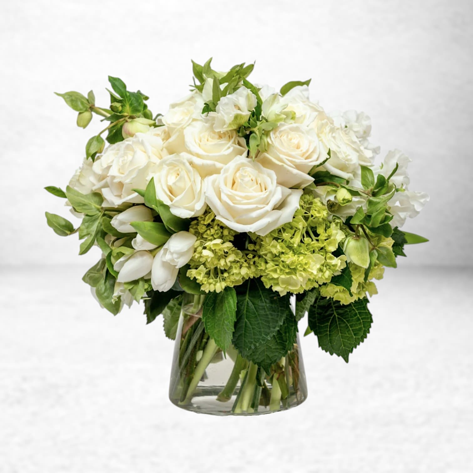 Ivory Comfort - Ivory Comfort is a serene expression of love, sympathy, and remembrance. Featuring soft ivory roses, creamy tulips, lush green hydrangea, and delicate seasonal blooms, this elegant arrangement brings a sense of peace and warmth to those who are grieving or in need of encouragement. Ideal for sympathy gestures, “thinking of you” moments, or sending gentle support. Handcrafted by Twigs and Blooms, with same-day delivery available in Galveston, Friendswood, League City, Dickinson, Alvin, and surrounding Texas Gulf Coast communities.  Substitution Policy: We thoughtfully create each arrangement with the freshest flowers available. On occasion, substitutions of similar blooms may be necessary, always preserving the overall look, color palette, and sentiment of the design.  