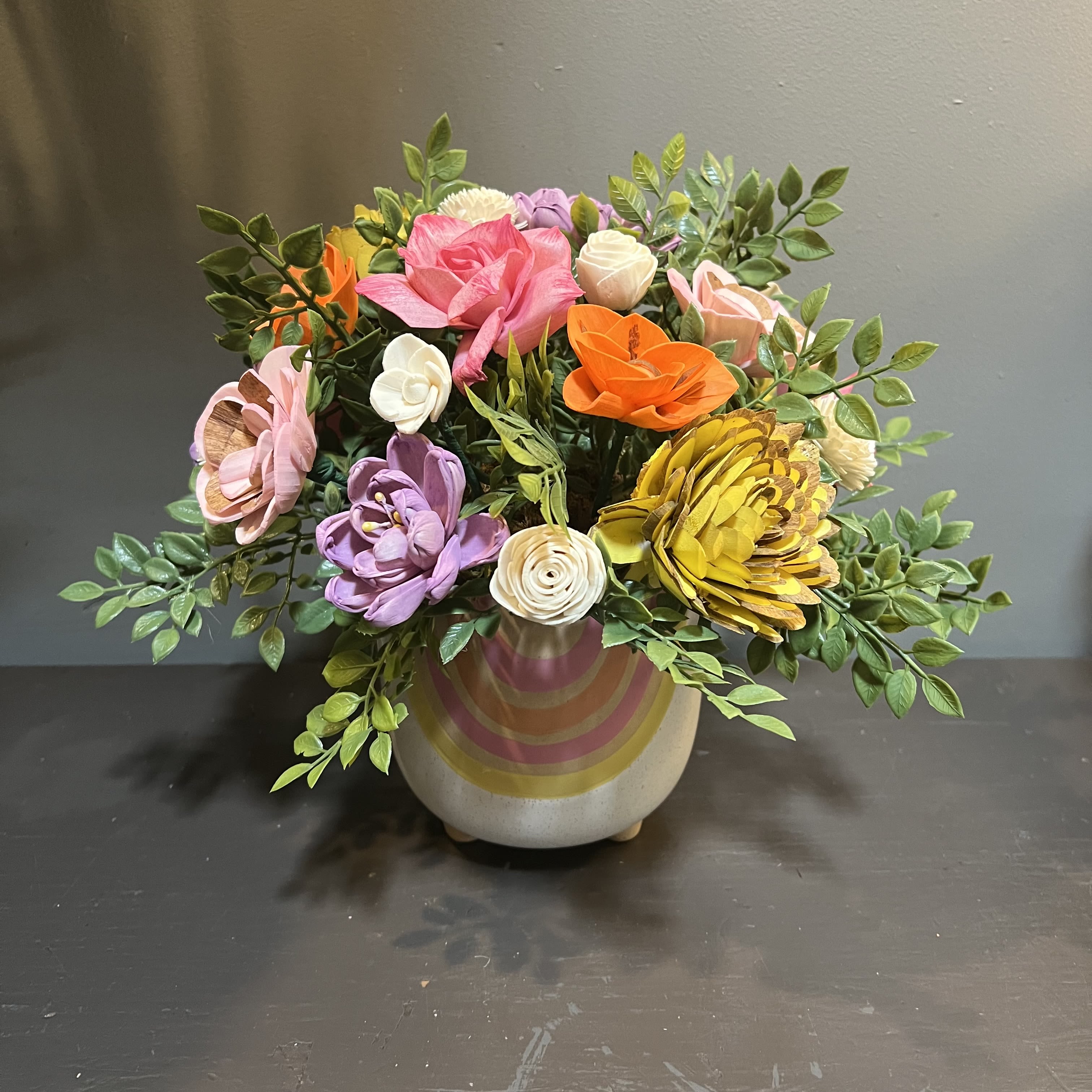 Sola Wooden Flower Centerpiece - Blooming Joy Sola Wooden Flower Centerpiece - Blooming Joy - Hand-dyed and hand-crafted in Minneapolis, these flowers made of balsa wood are a wonderful everlasting floral arrangement - great for those with allergies! Can be used as a natural essential oil diffuser too! Arrives in a ceramic vase. Approx. Dimensions: 11"Tx11"W