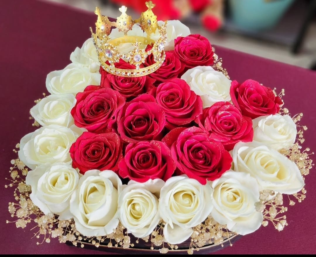 Queen of Hearts - Let the queen in your life know how much she means to you. Heart arrangement features red and white roses, baby breath and a small crown. 