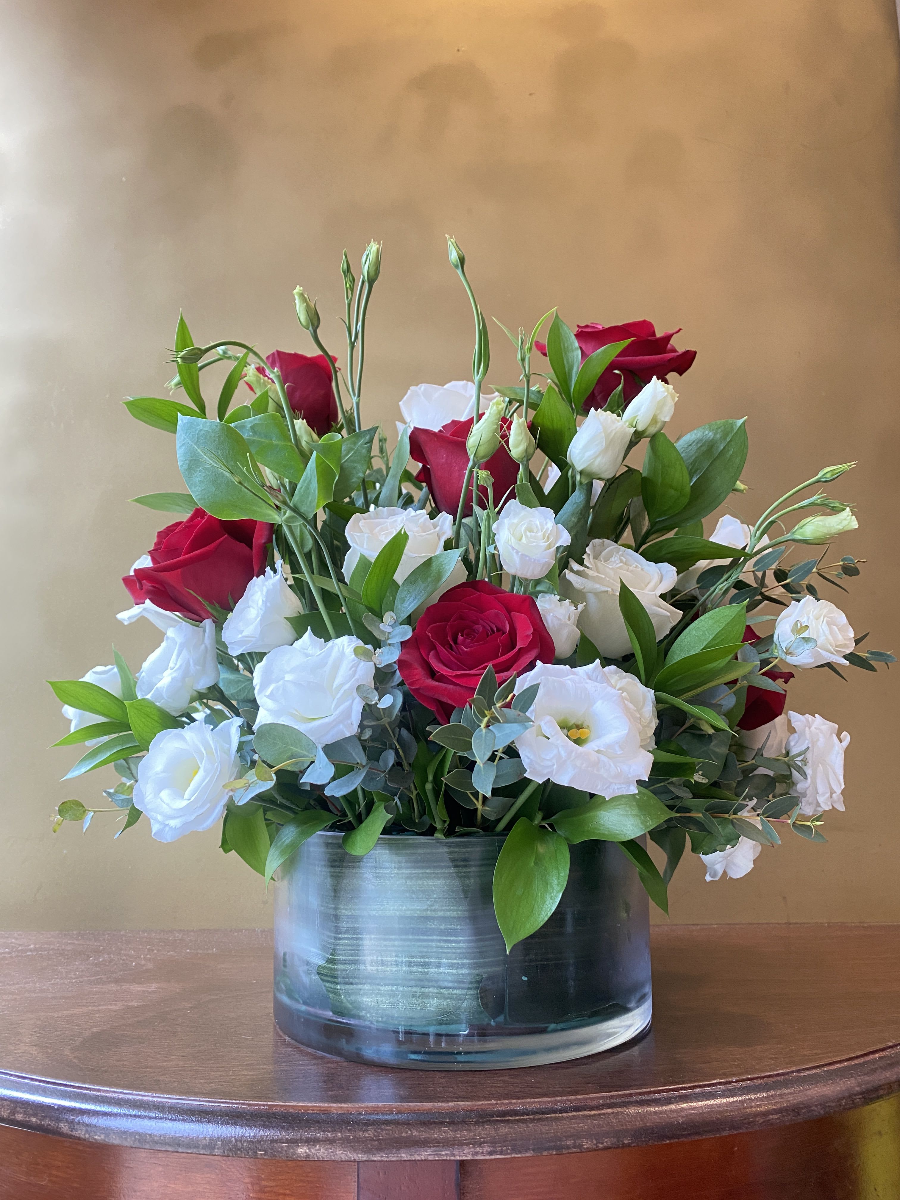 Eternal Bloom - Serenade your love with this beautiful bouquet of red and white roses! Designed with premium red roses and elegant white lisianthus in a leaf-lined cylinder vase, this arrangement is sure to capture anyone’s heart.