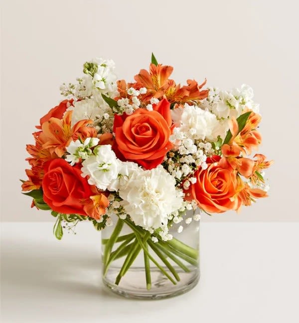 Orange Delight  - Through this charming arrangement bring some extra color to that special someone. Arrangement features orange roses, white carnations, stock and other. 