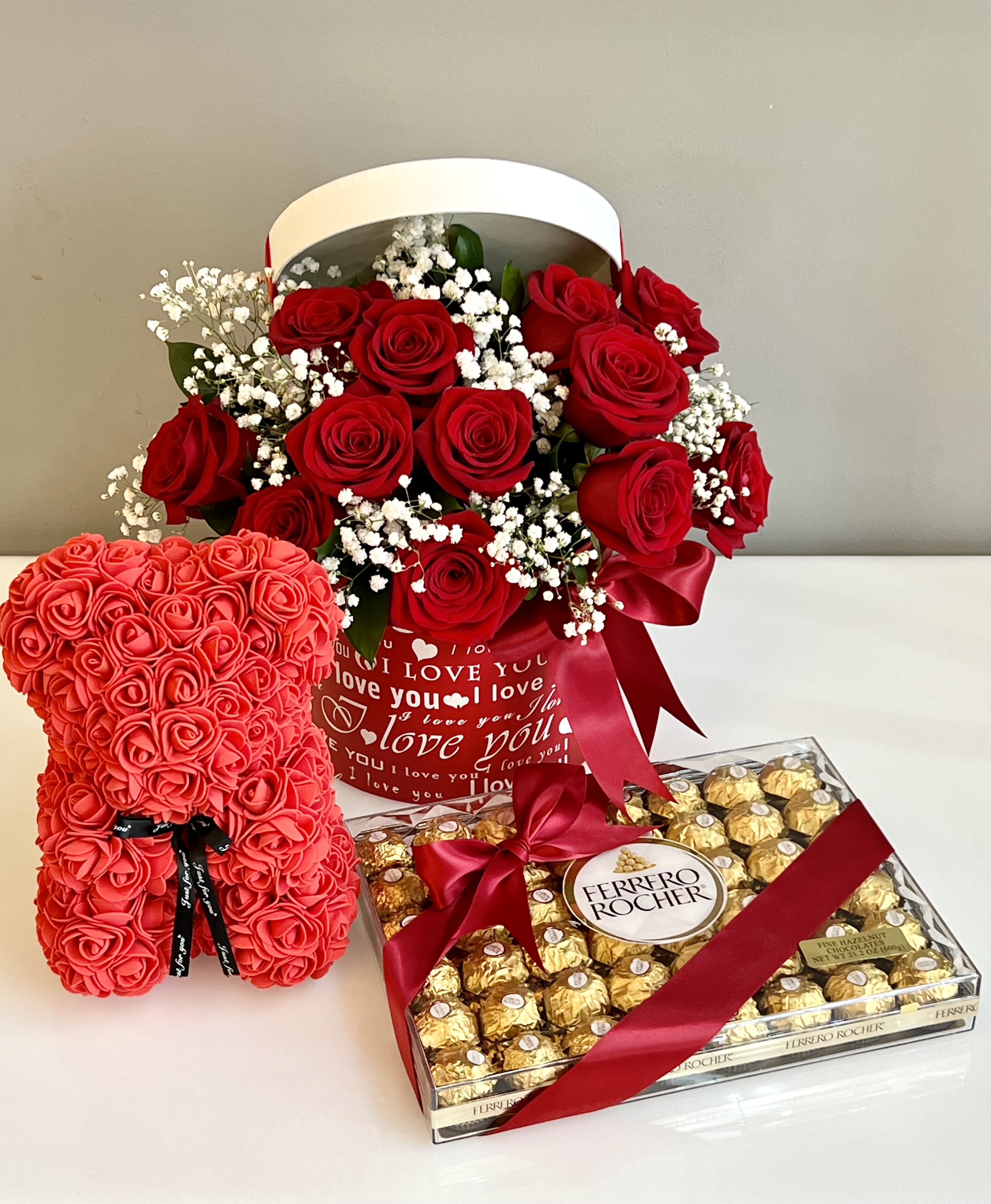 Love Trio gift set ™ Love Trio gift set ™ - Gift set includes: Dozen fresh Rose arrangement in a box, Rose Bear made of artificial flowers, and box of Ferrero Rocher chocolates