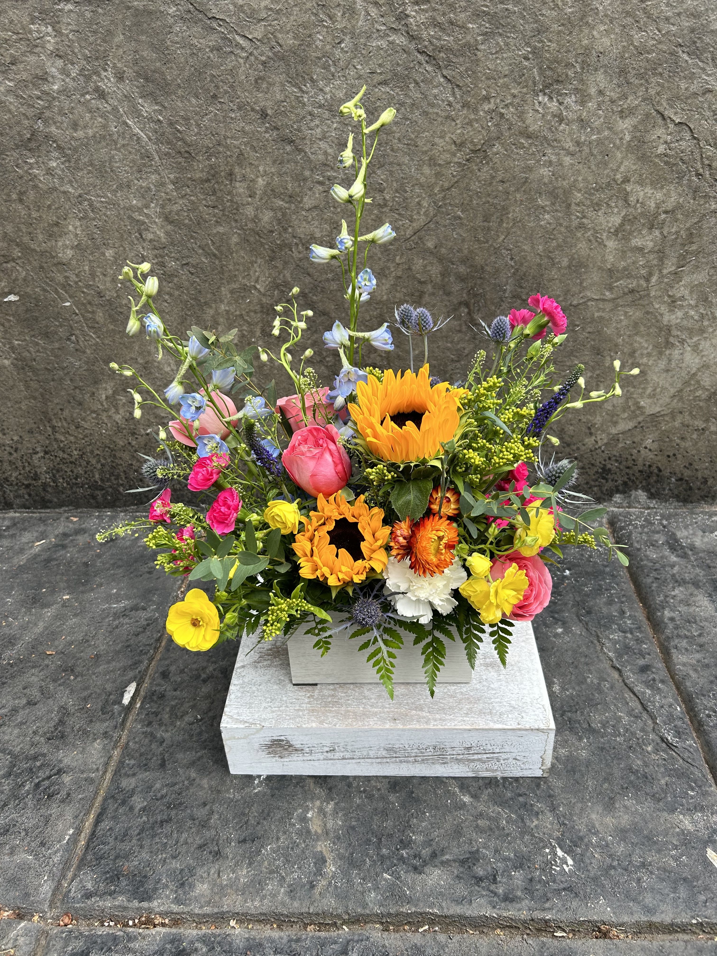 Vibrant Summer - Summer season is here so it's time for those sunny sunflowers, mixed with delphiniums, roses, and other pretty filler blooms in a wood box container. 