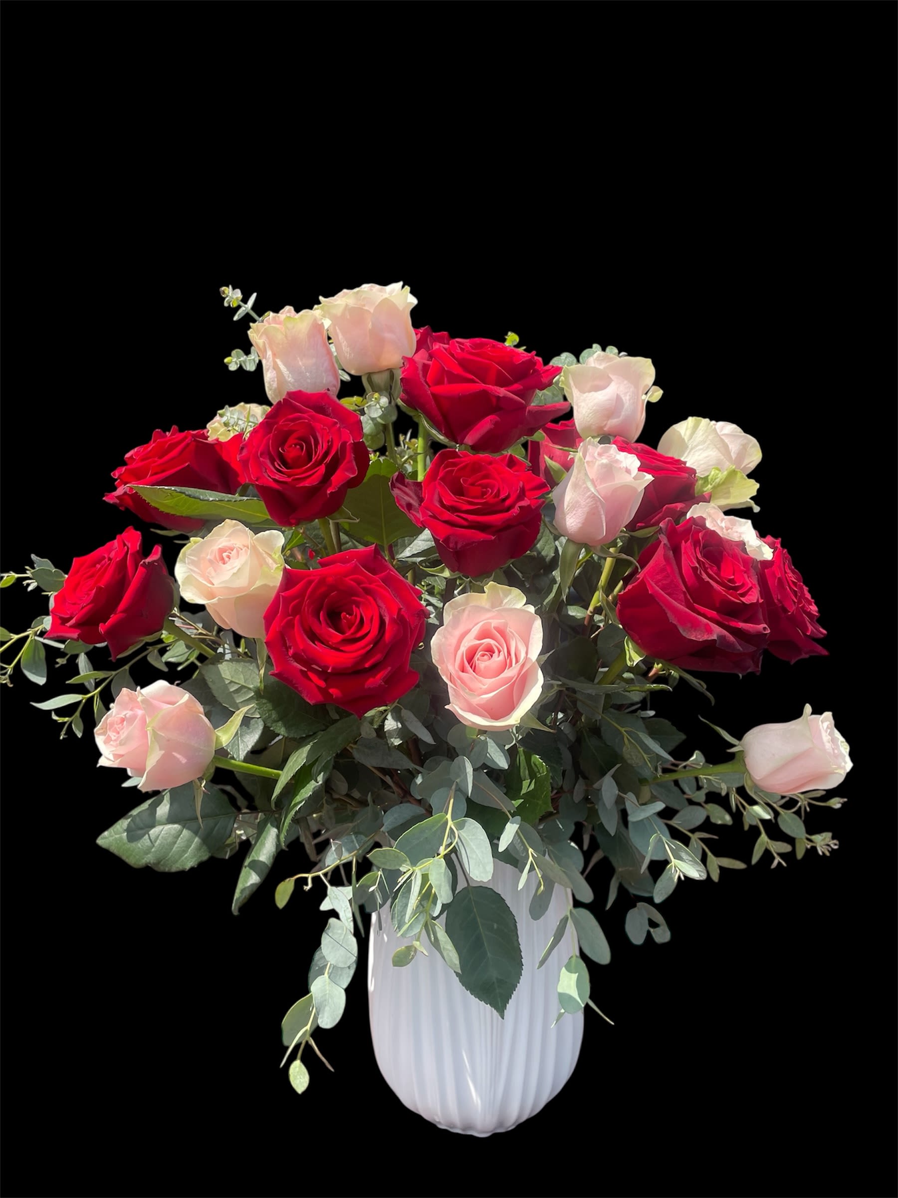 PINK AND RED ROSES PINK AND RED ROSES - A stunning arrangement of 24 radiant roses gracefully nestled in a white tulips ceramic vase. A timeless expression of love and beauty, perfect for any heartfelt occasion.