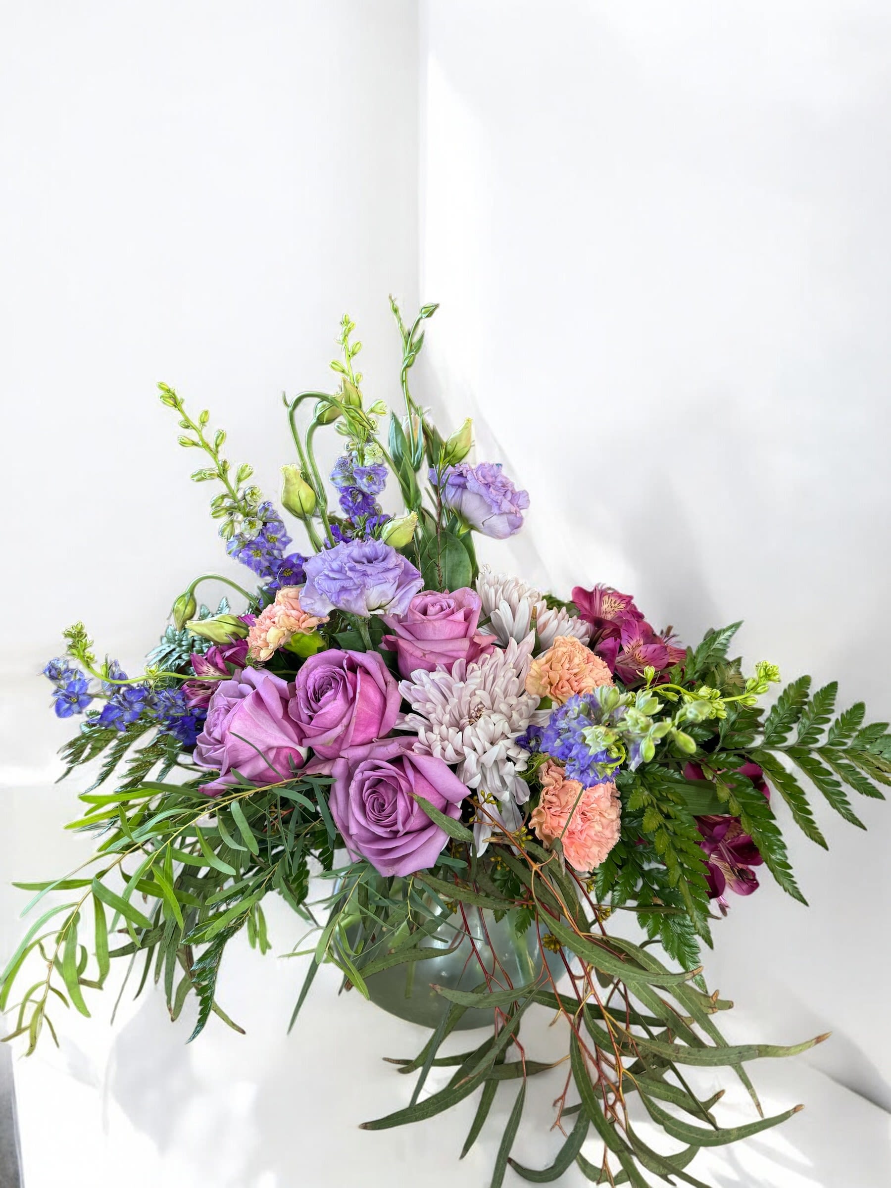 Whispering Blooms - A sophisticated arrangement with cool or bright colors and mixed florals.  An elegant and charming bouquet perfect or any occasion.