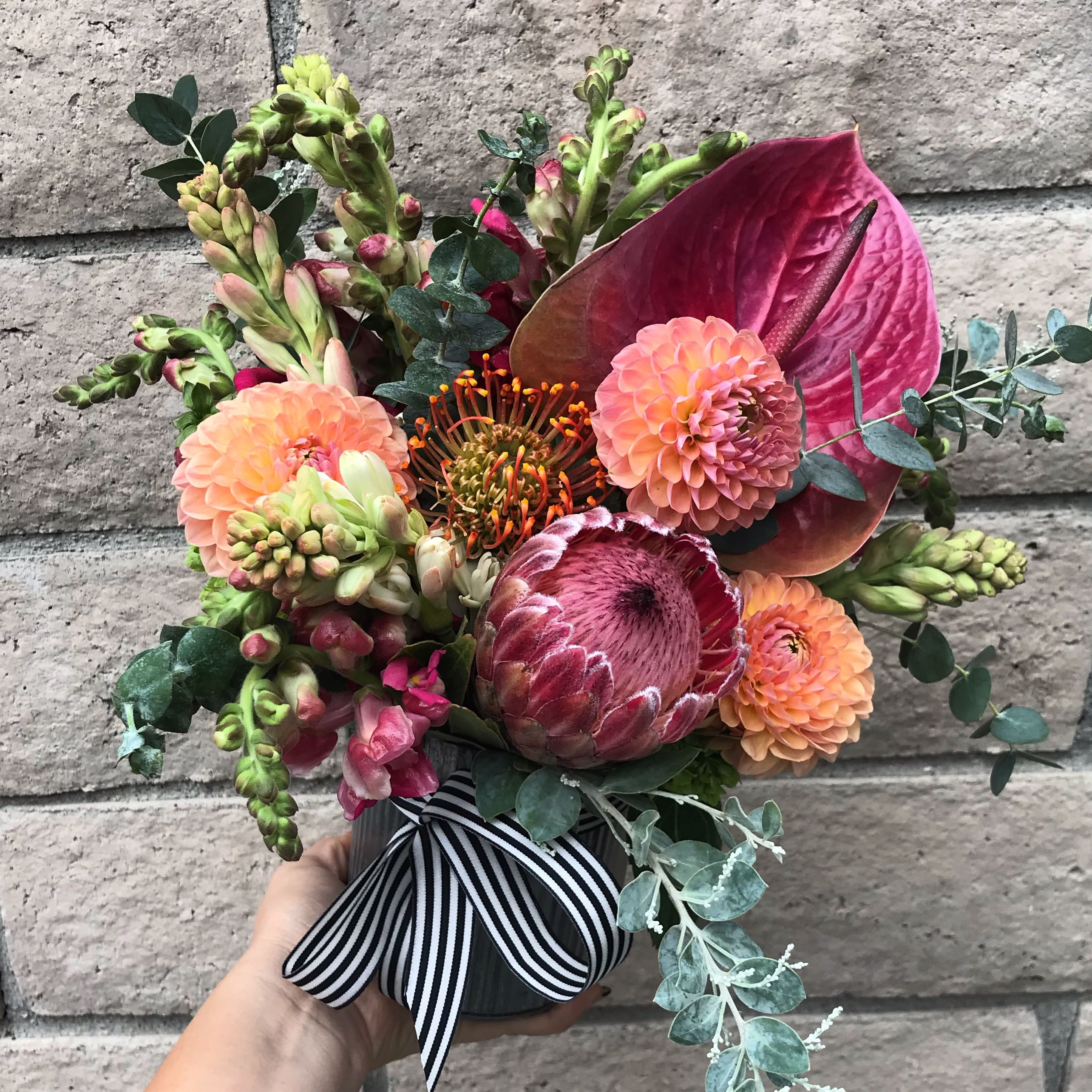 Watermelon Sugar - Peach Dahlias, Blush Anthurium, fragrant Tuberose and local pink Protea make this gift an absolute stunner; full of fragrance, textures and style. Seasonal tweaks may be necessary to deliver the freshest and most beautiful gift. 