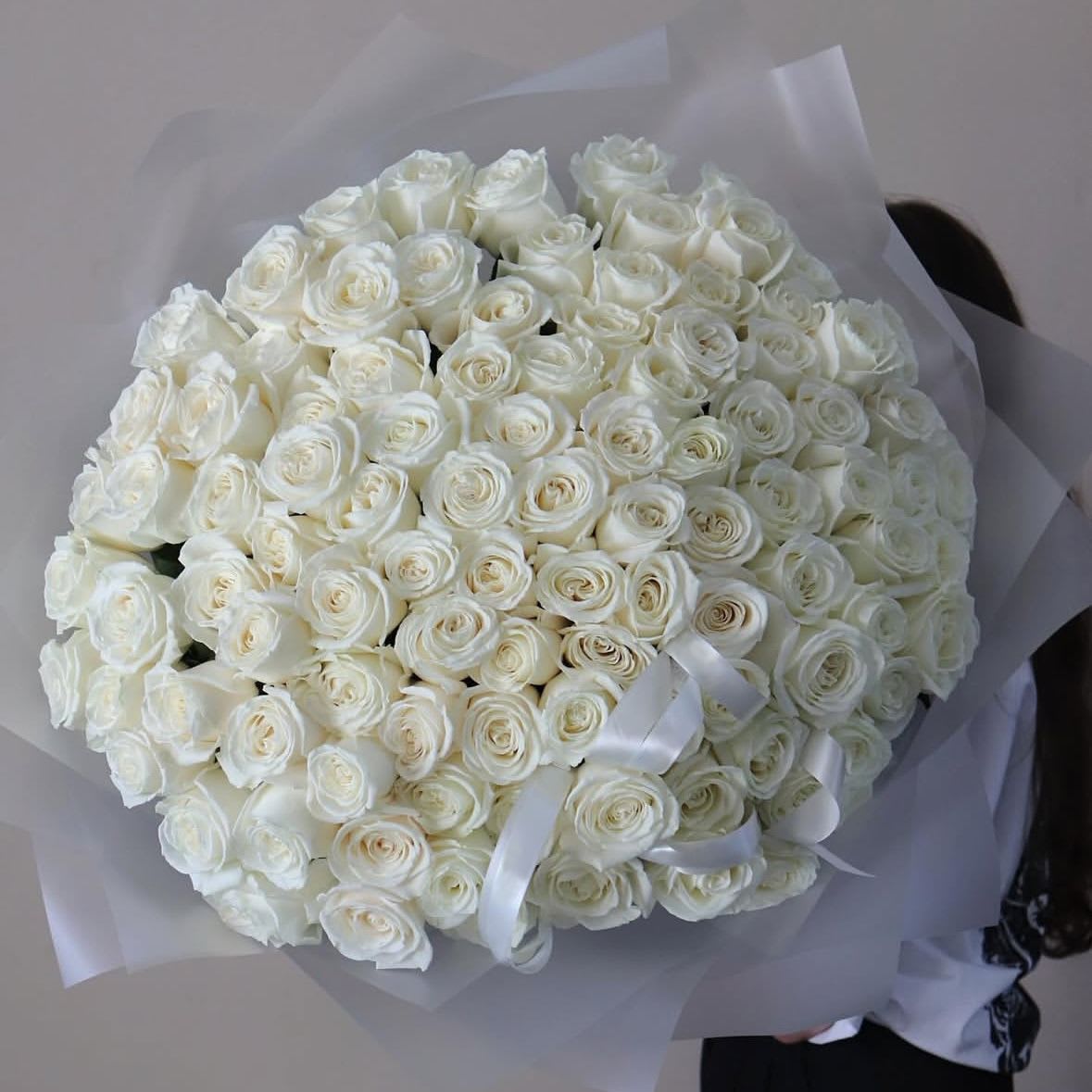 100 White roses - A stunning bouquet of fresh white roses, perfect for any occasion. Wrapped in matte film and tied with a ribbon. This elegant arrangement is sure to impress. Delivered in an aqua box for ultimate freshness.