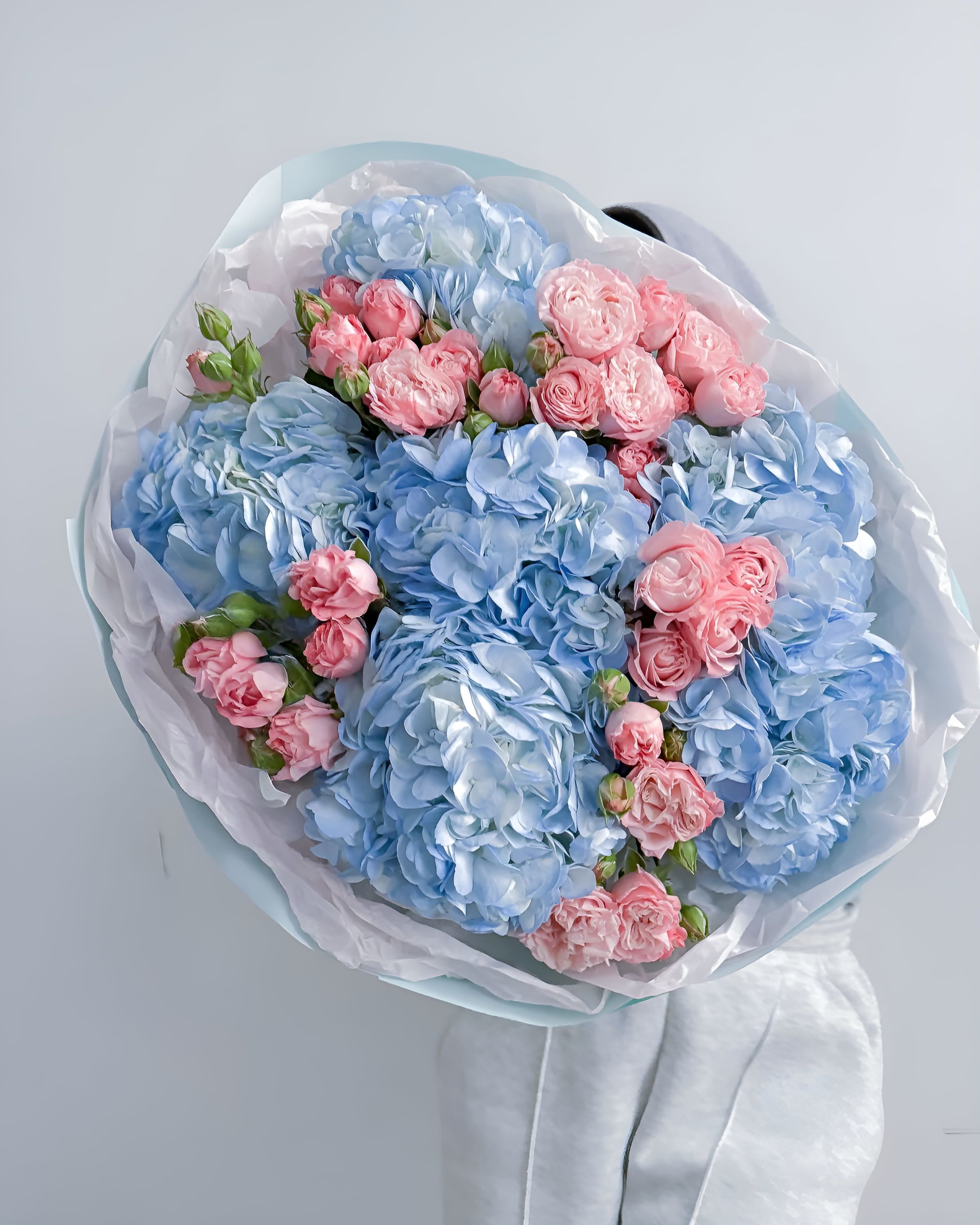 Blueberry Kiss - A charming mix of sky-blue hydrangeas and soft pink spray roses, Blueberry Kiss blends cool elegance with romantic warmth. Perfectly balanced in color and texture, this bouquet brings a refreshing and joyful mood — ideal for birthdays, new beginnings, or a heartfelt gesture of affection.