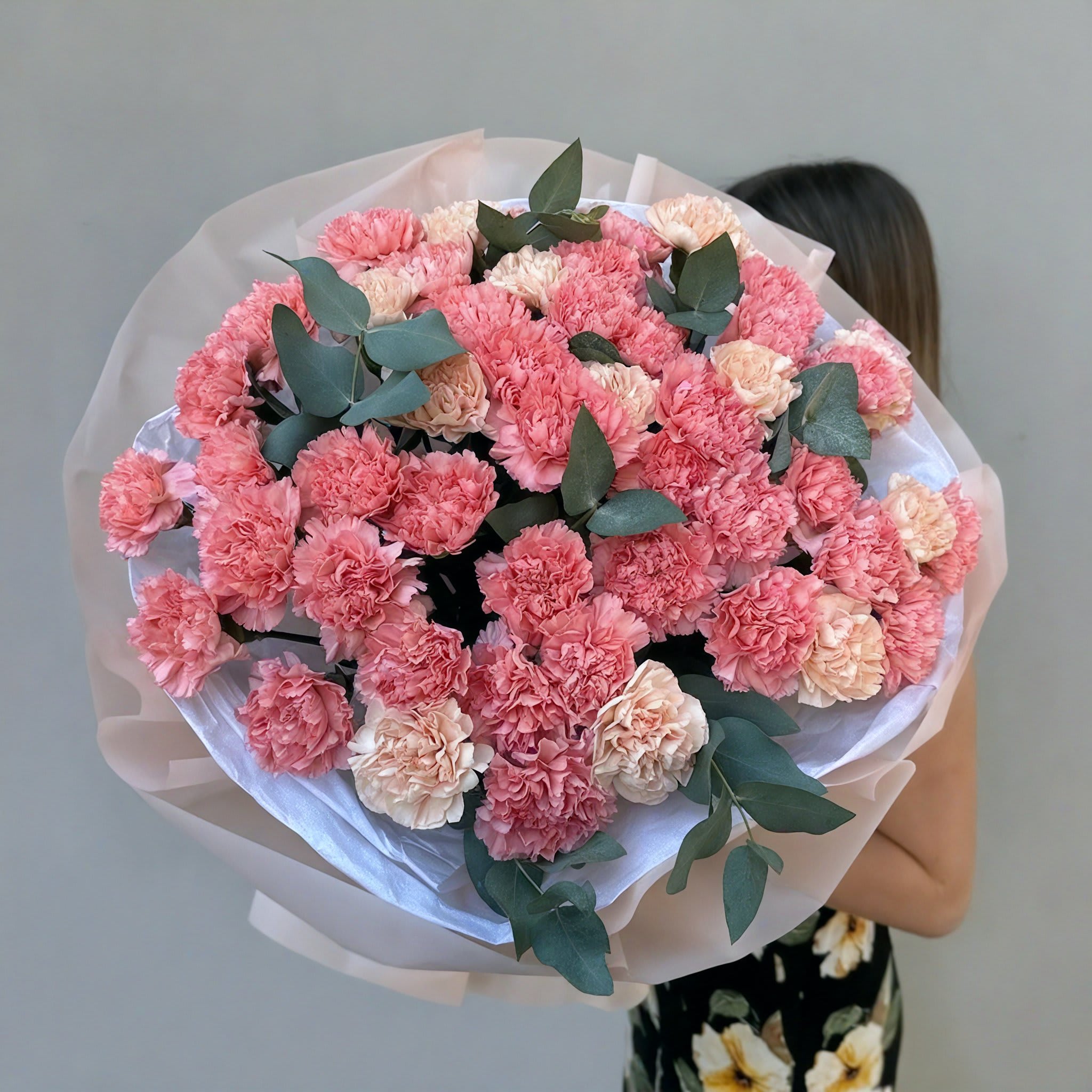 Carnations and eucalyptus - A stunning bouquet of fresh flowers in vibrant colors, perfect for any occasion. Wrapped in matte film and tied with a ribbon. This elegant arrangement is sure to impress. Delivered in an aqua box for ultimate freshness.