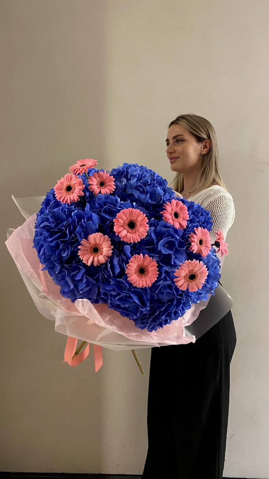 Electric Bloom - A boldly eccentric duo-bouquet for lovers of the unexpected. Vivid blue hydrangeas form a voluminous cloud, streaked with bursts of glamorous hot pink gerberas. Its rounded shape creates maximum fullness and impact, while the daring color contrast guarantees second glances. Perfect for that one-of-a-kind woman — playful, fearless, and fabulously unpredictable. Gift her this floral wonder, and you’ll be remembered forever.  Composition: Hydrangea, gerbera 