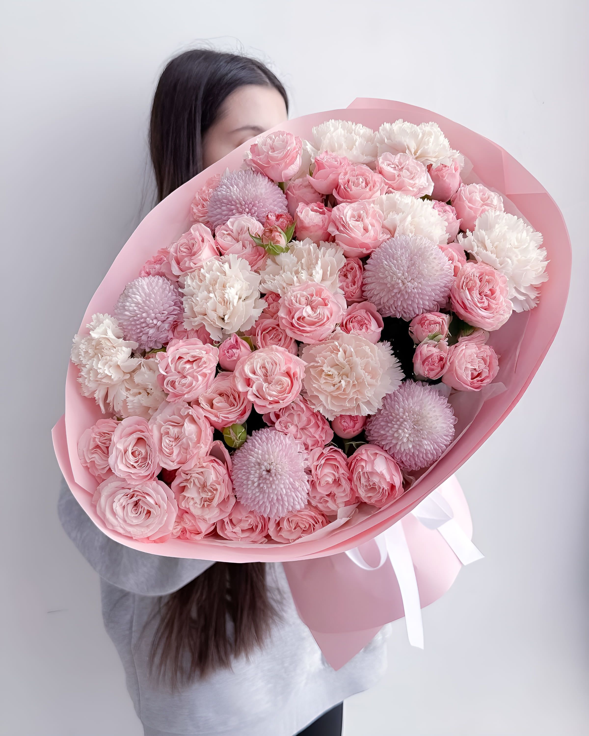 Marshmallow Glow - A delightful mix of pastel pink chrysanthemums, creamy carnations, and lush spray roses — Marshmallow Glow brings softness and charm in every petal. Its round shapes and candy-like colors make it the perfect bouquet for sweet occasions, gentle surprises, or to simply make someone smile.