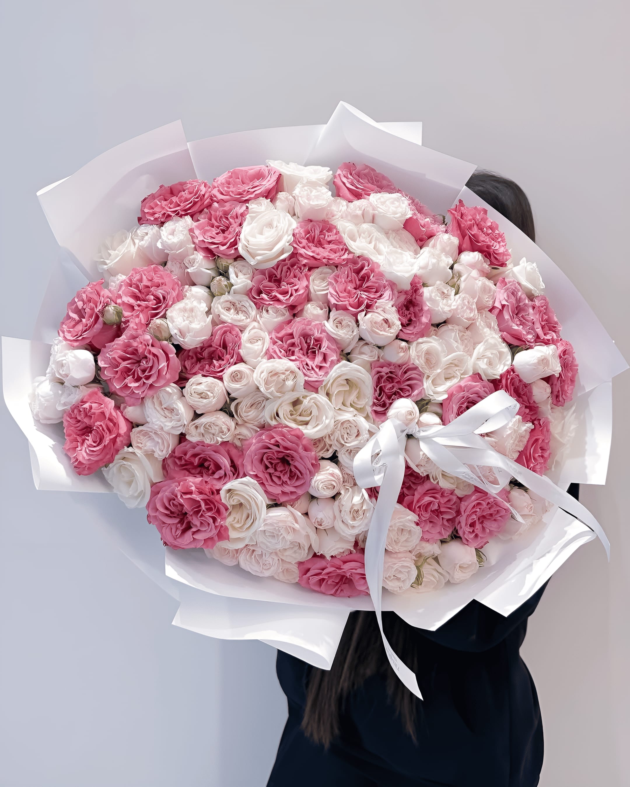 Rose Majesty - A luxurious medley of vibrant fuchsia, blush pink, and creamy white roses — Rose Majesty is a bouquet that radiates opulence and romantic charm. With densely packed garden and spray roses, this design is perfect for grand gestures, heartfelt celebrations, or anniversaries that deserve something truly unforgettable.  Size on the photo: Deluxe.