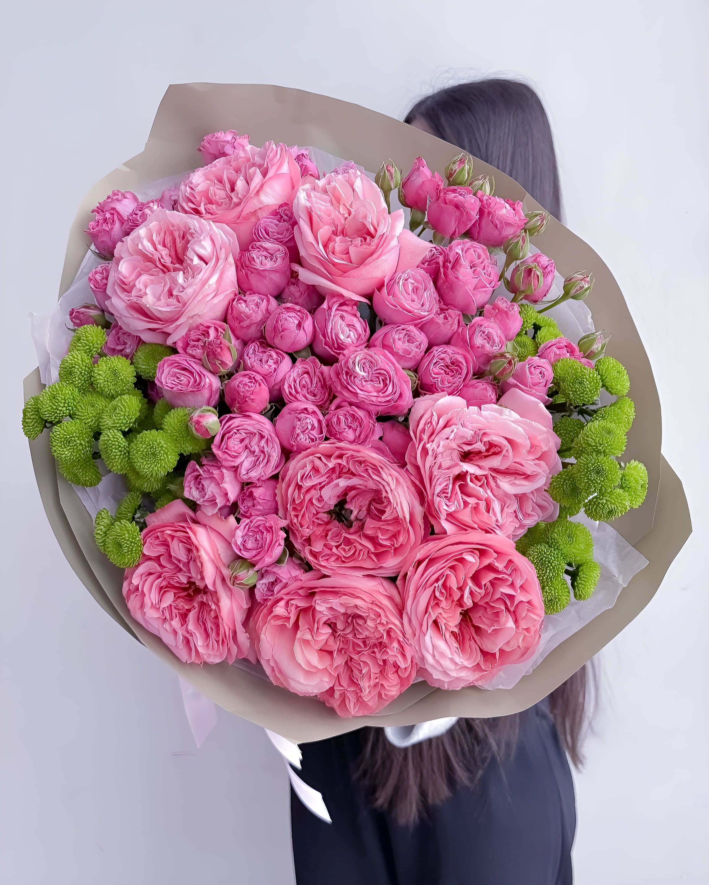 Rosy Charm - A bold and cheerful bouquet of vibrant pink garden and spray roses, balanced by bright green button chrysanthemums. Rosy Charm bursts with energy and affection — a perfect pick for birthdays, celebrations, or simply to make someone feel adored with color and volume.