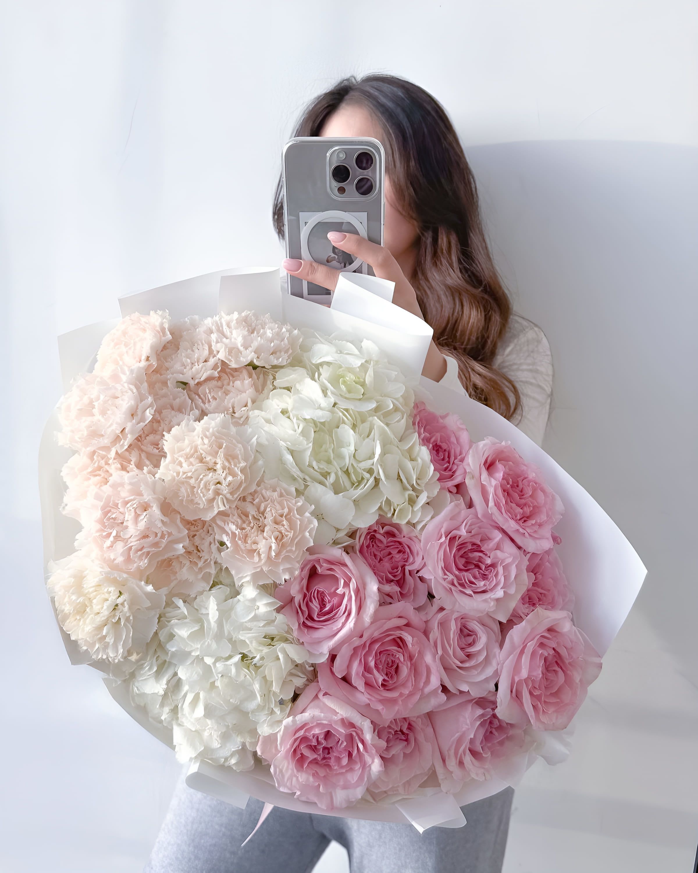 Vanilla Blush - A graceful bouquet combining powder-pink roses, creamy carnations, and snow-white hydrangeas. Vanilla Blush radiates soft femininity and timeless charm — ideal for romantic gestures, bridal showers, or elegant celebrations where subtle beauty speaks louder than words.