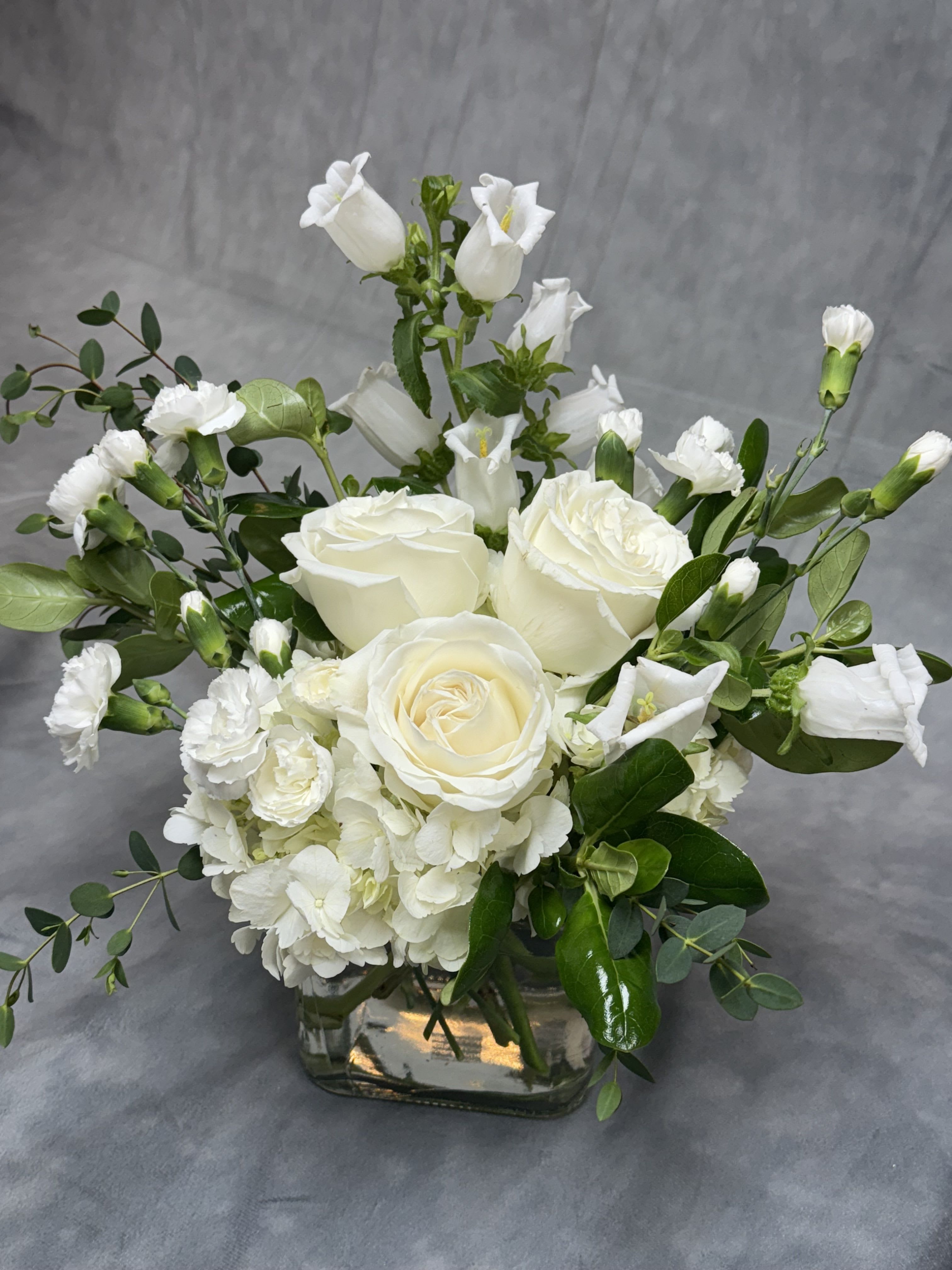 PEACEFUL MEMORIES - During this delicate time, words often fall short in expressing our deepest condolences. That's why we've carefully crafted a sympathy flower arrangement to convey the unspoken emotions of love, support, and remembrance. Each bloom in this arrangement has been chosen to symbolize comfort and enduring love. May this arrangement serve as a heartfelt tribute, bringing solace and peace to you and your loved ones as you navigate this difficult moment. With sincere sympathies,  Each arrangement comes with a small card with a small note.  Please put your message in the note box at checkout for us to write it on your card and what is the occasion as well.