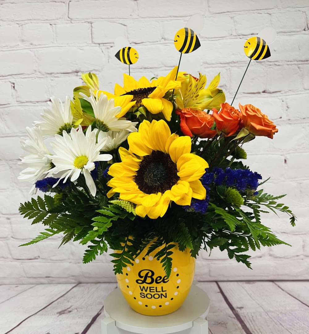 Garden of Wellness Garden of Wellness - Wish them well with this bright, beautiful bouquet! From orange roses and red alstroemeria, to lavender asters and mini sunflowers, this rainbow of blooms will brighten their space - and their spirits. It's hand-delivered in a charming "Bee Well Soon" pot with darling bee decorations.