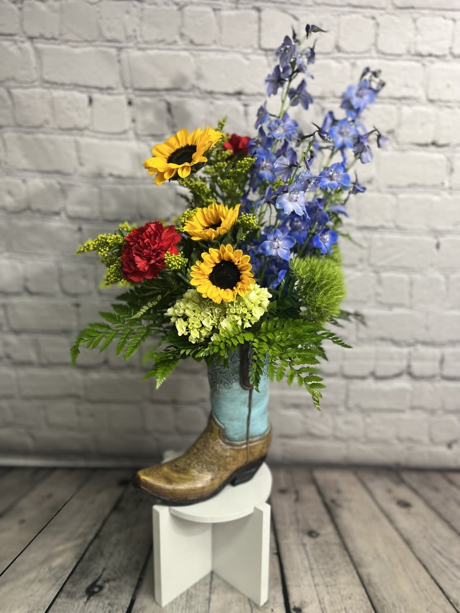 WILD WEST WILD WEST - The perfect arrangement to send to anyone who loves the Texas wildflower look. **BOOT COLOR MAY VARY. BROWN OR BLUE**