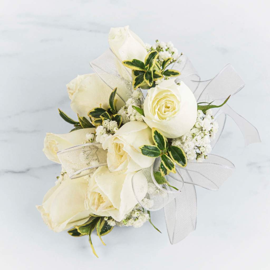 White Rose Corsage White Rose Corsage - A classic white corsage with silver sheer ribbon- looks good with any outfit. A perfect compliment to any prom, formal, or wedding event. Pair it effortlessly with any color palette to create a refined, memorable impression.