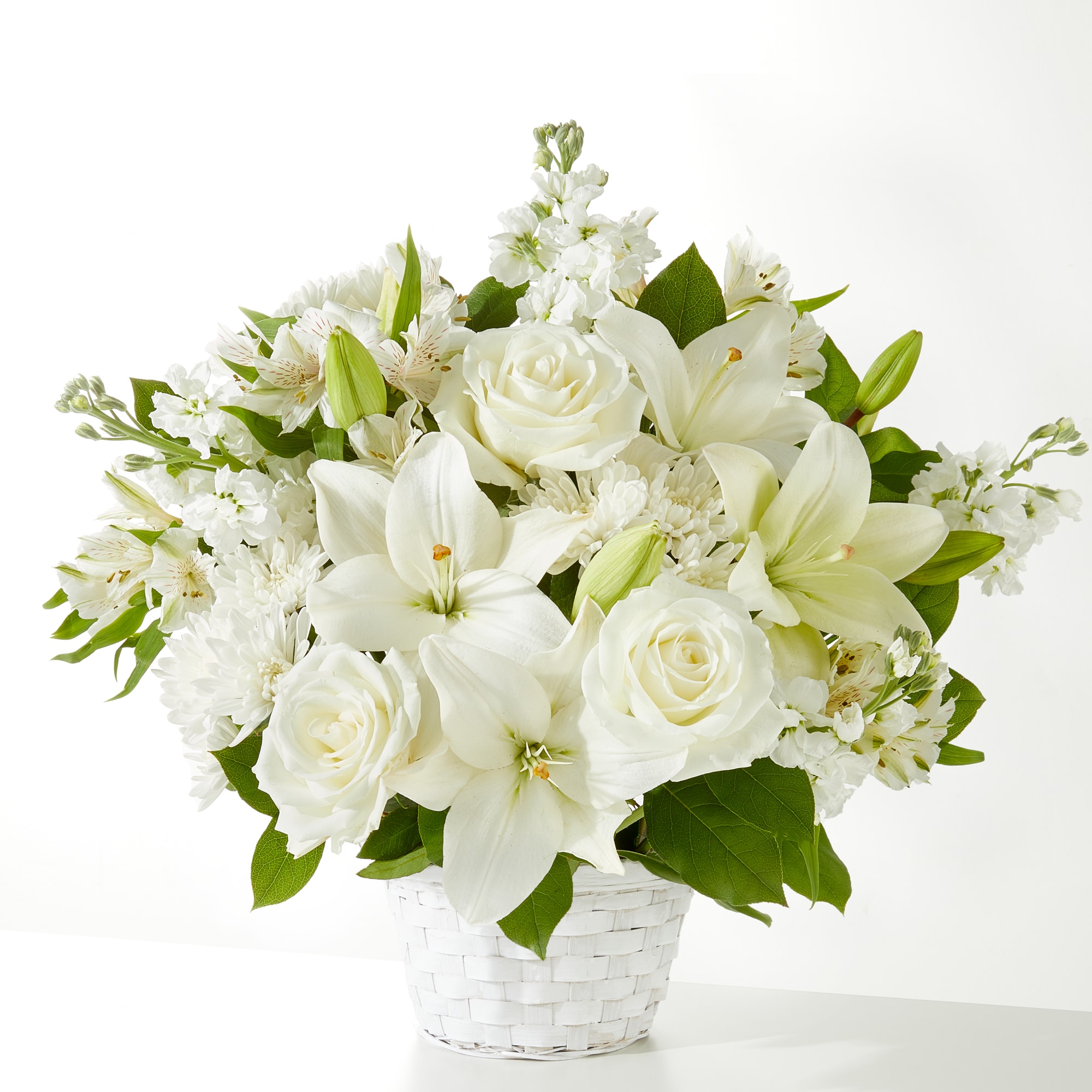 Peaceful Reflections Peaceful Reflections - A serene all-white arrangement featuring roses, lilies, alstroemeria, and stock, beautifully gathered in a white basket. Thoughtfully designed to offer comfort and hope, it’s a heartfelt choice for sympathy, memorial services, or sharing quiet support with loved ones. Approximately 16" H x 18" W.