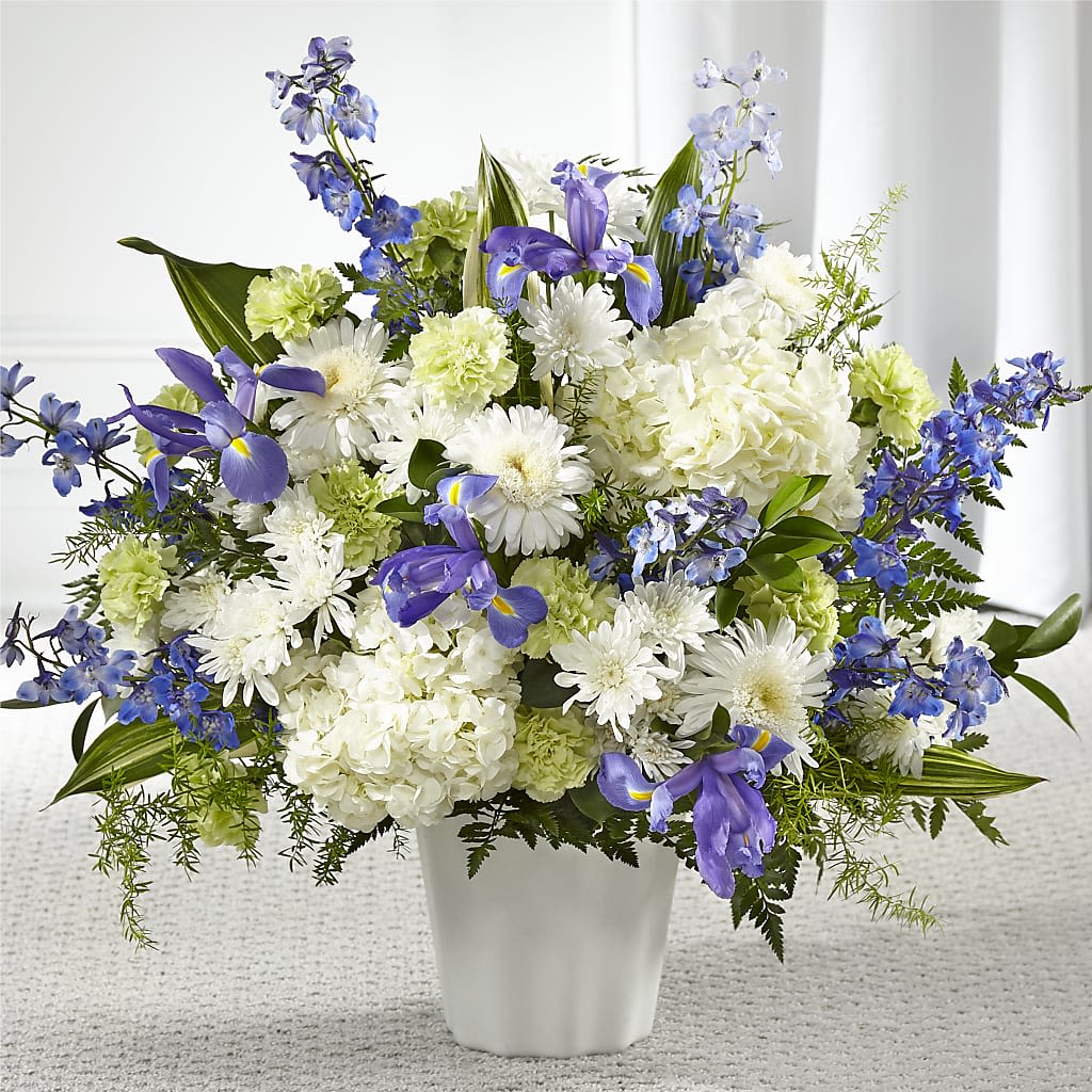 Soft Serenity Floor Basket - Our Soft Serenity Floor Basket is a beautiful and comforting tribute, designed to bring peace and solace to a loved one during difficult times.   The fresh mix of blue and white iris, hydrangea, delphinium, and cremon mums is chosen to convey your heartfelt condolences and remind your loved one of your love and support.