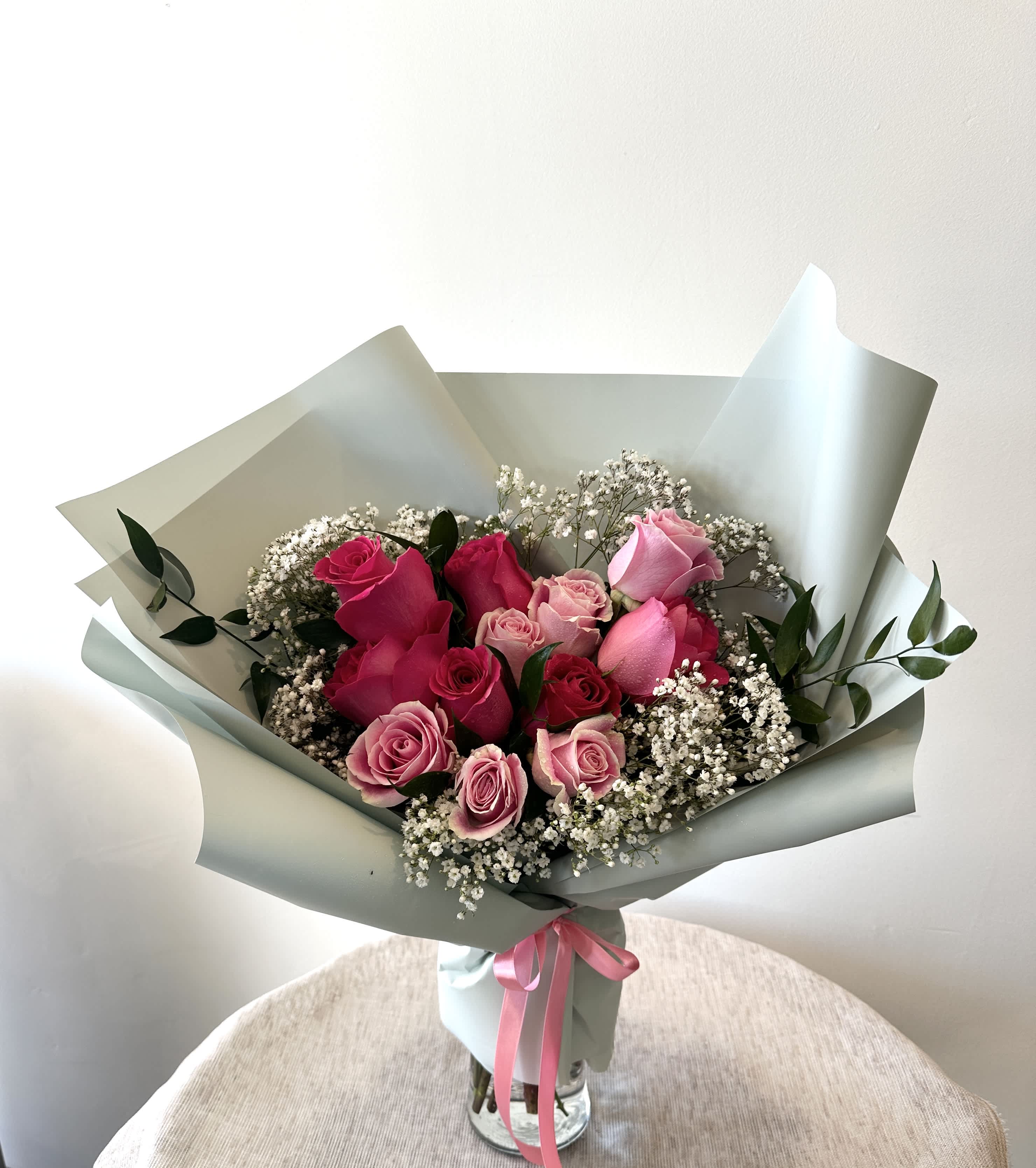 One Dozen Mixed Pink Roses Hand Bouquet (Vase not included) - Surprise your loved one with Flower Talk's charming hand bouquet of a dozen pink roses, expertly crafted to express your affection and add a touch of beauty to their day.