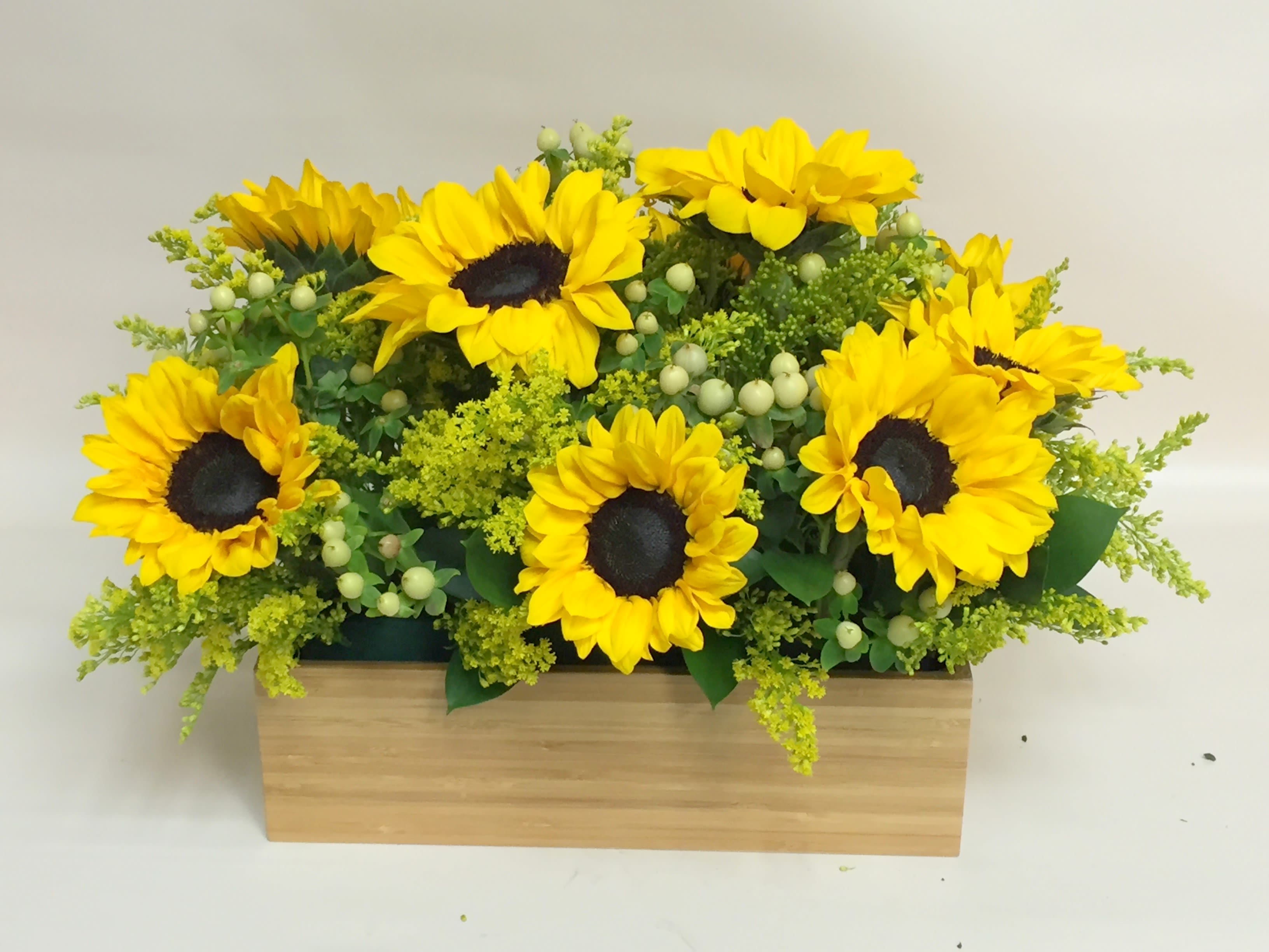 Sunflower Splash Sunflower Splash - Glass cube with cheery sunflowers and accent flowers. Can be designed in a glass bowl or cylinder...upgrades include wood boxes.