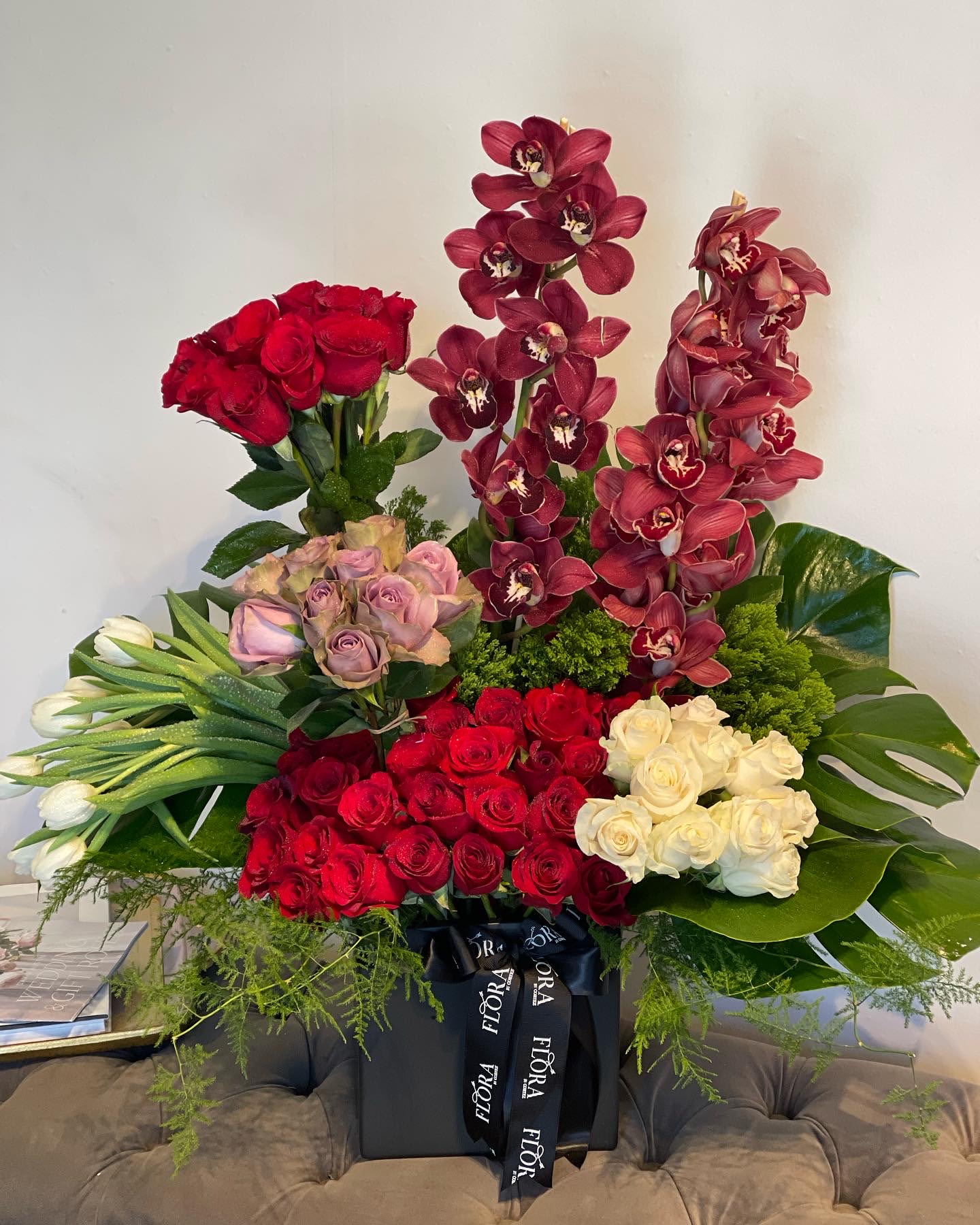 Red &amp; White Roses, Tulips, Cymbidium &amp; Leaves Floral Garden Arrangement - Beautiful floral garden arrangement featuring red and white roses, tulips, cymbidium orchids, and lush leaves. Perfect for adding a touch of elegance and charm to any occasion. Order this unique and vibrant arrangement today!