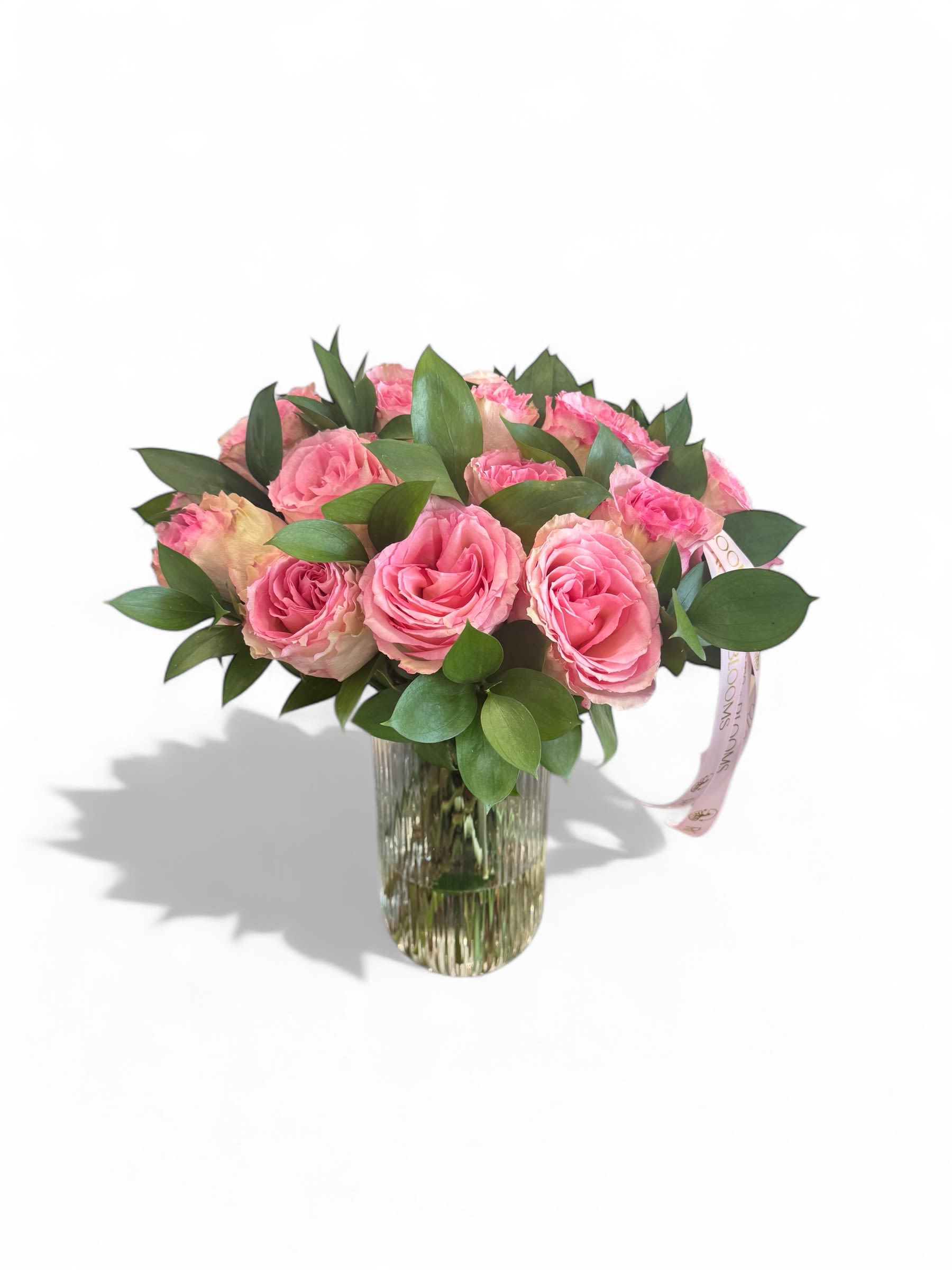 Twelve in Bloom - 12 in Bloom features 12 elegant pink roses, nestled and fresh lush greenery, all arranging a classic clear glass vase