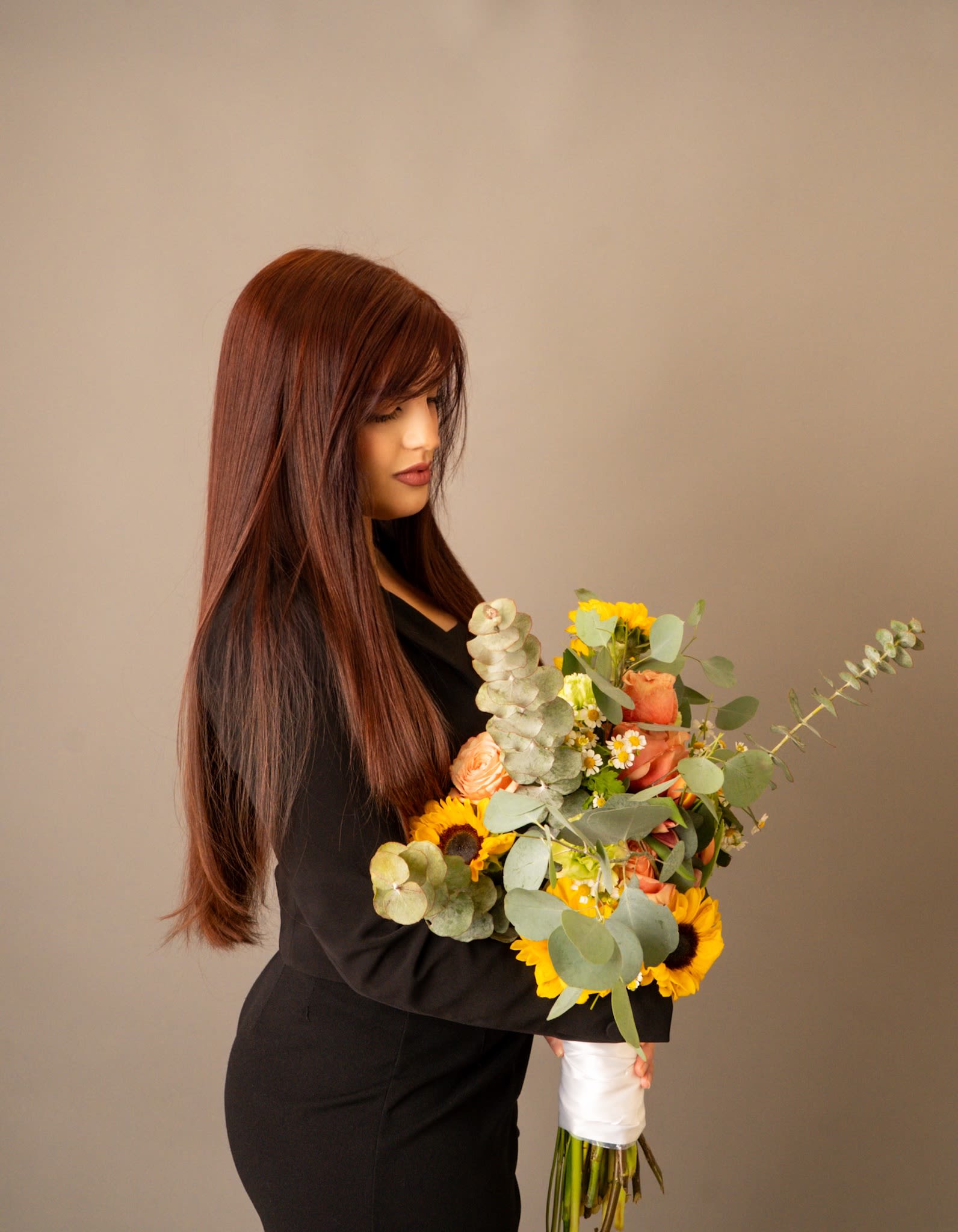 Golden Grace - An organic hand tied bouquet that feels like a ray of sunshine. Designed with a light, natural mix of sunflowers, seasonal roses, two varieties of eucalyptus, and textured greenery all arranged without paper wrapping.  Soft, joyful, and effortlessly elegant. Perfect for brightening a space or gifting a warm, thoughtful moment.