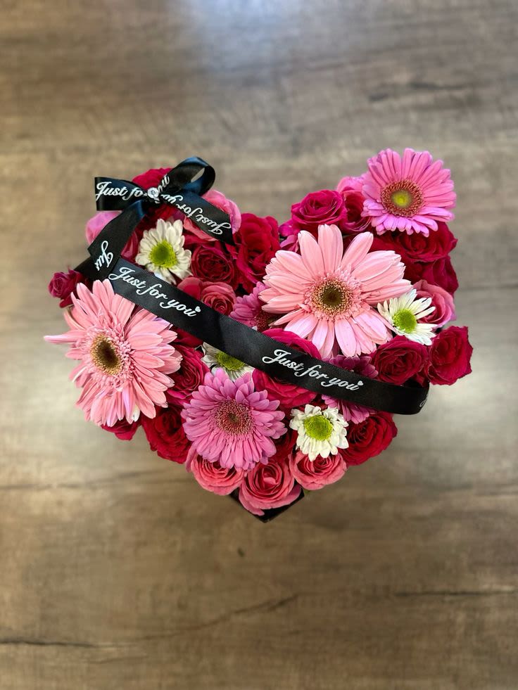 Love in bloom Love in bloom - Heartfelt Blooms – A Floral Expression of Love Celebrate love and beauty with our Heartfelt Blooms — a stunning arrangement of mixed flowers, beautifully arranged in a charming heart-shaped box. Whether it's for a special occasion, an anniversary, or just to express your feelings, this romantic bouquet is the perfect way to show someone how much they mean to you. The soft, delicate petals of our fresh mixed flowers are complemented by a luxurious ribbon, adding an elegant touch to this heartfelt gift. It’s a timeless piece that brings warmth, joy, and a personal touch to any moment. Customizable with different flower types and ribbon choices. Pricing may vary based on custom selections. A gift as beautiful and lasting as your love.