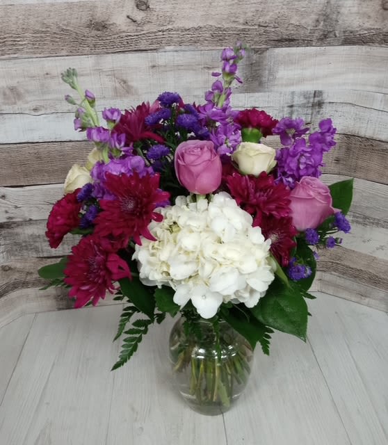 Berry Smoothie - Bursting with juicy color and playful charm, the Berry Smoothie arrangement is a vibrant blend of rich magentas, deep raspberry tones, and soft berry pinks. Featuring a luscious mix of  this arrangement is both refreshing and indulgent—just like your favorite fruity treat. Accented with lush greenery and artful textures, Berry Smoothie brings a pop of color and a dash of sweetness to any space. Perfect for birthdays, thank-yous, or just because.