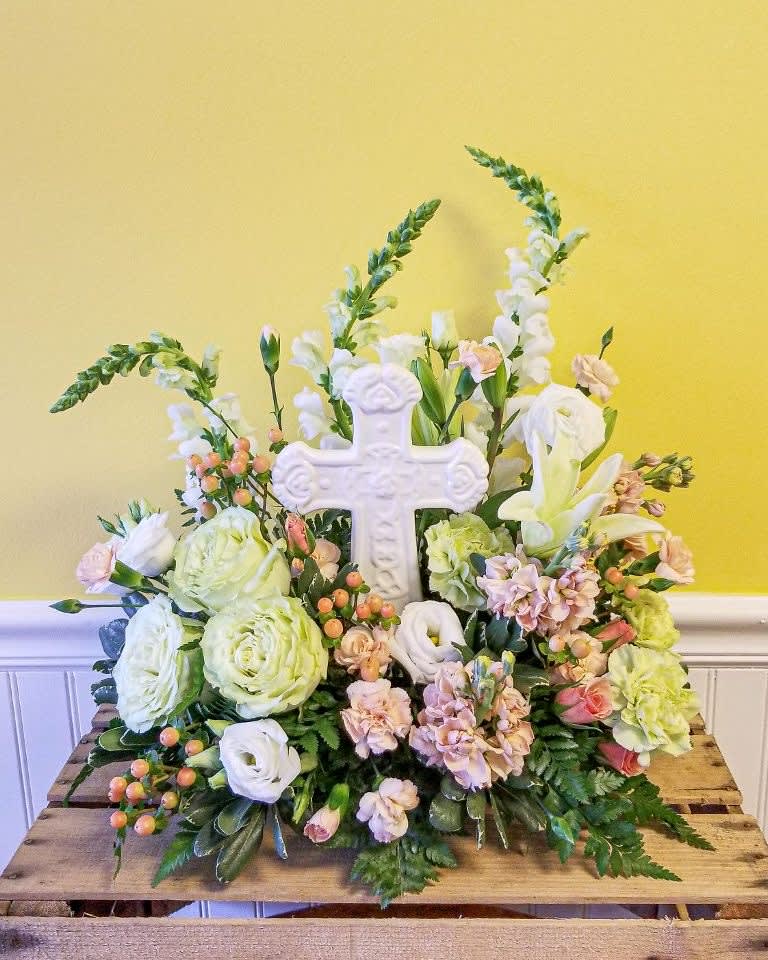 Flowering  Cross - White ceramic cross nestled in soft traditionally early spring colors . 