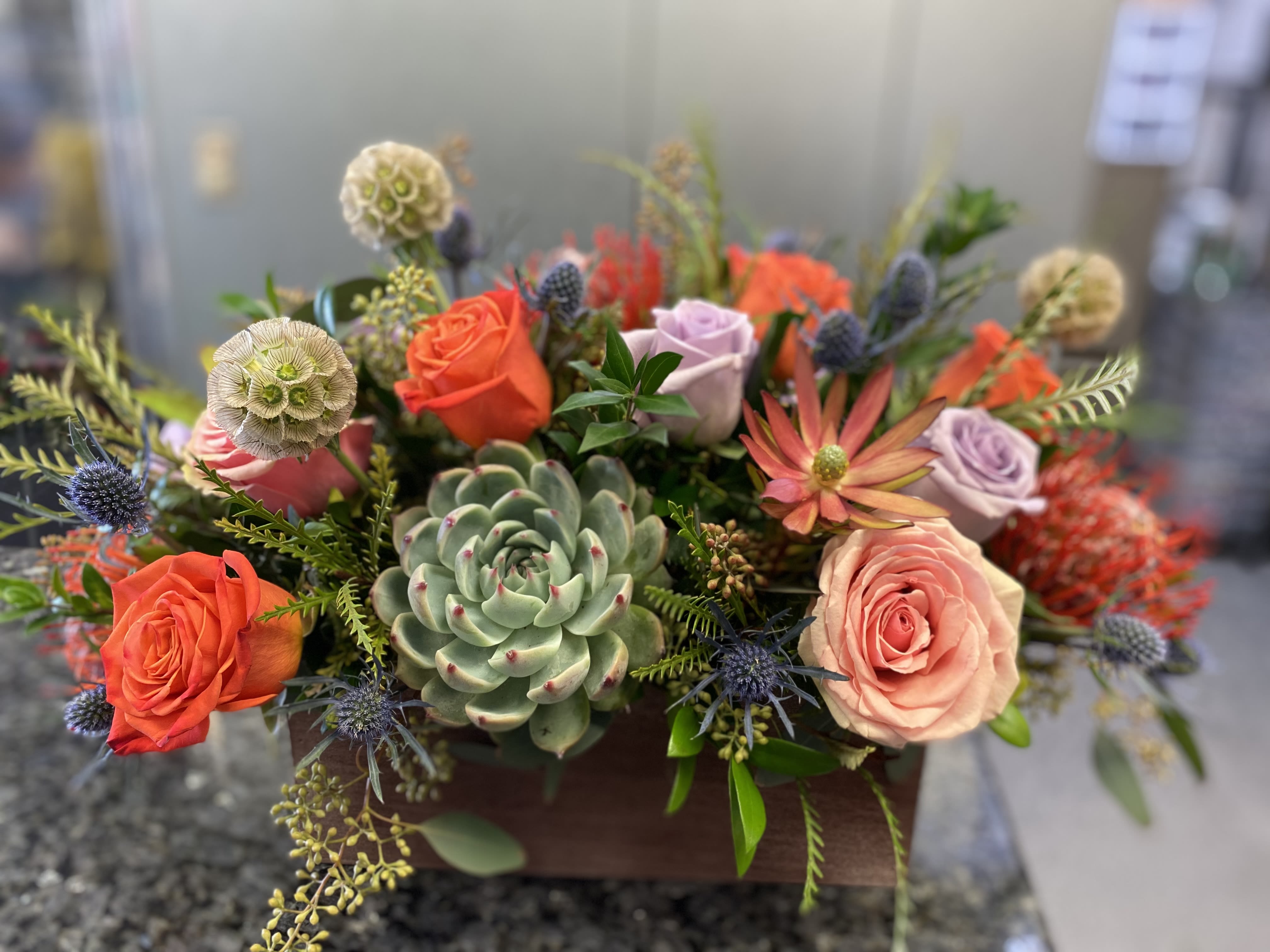 In the Meadows - A Low and Airy Bright Spring Mixed Centerpiece in a Rectangular Wooden Box. 