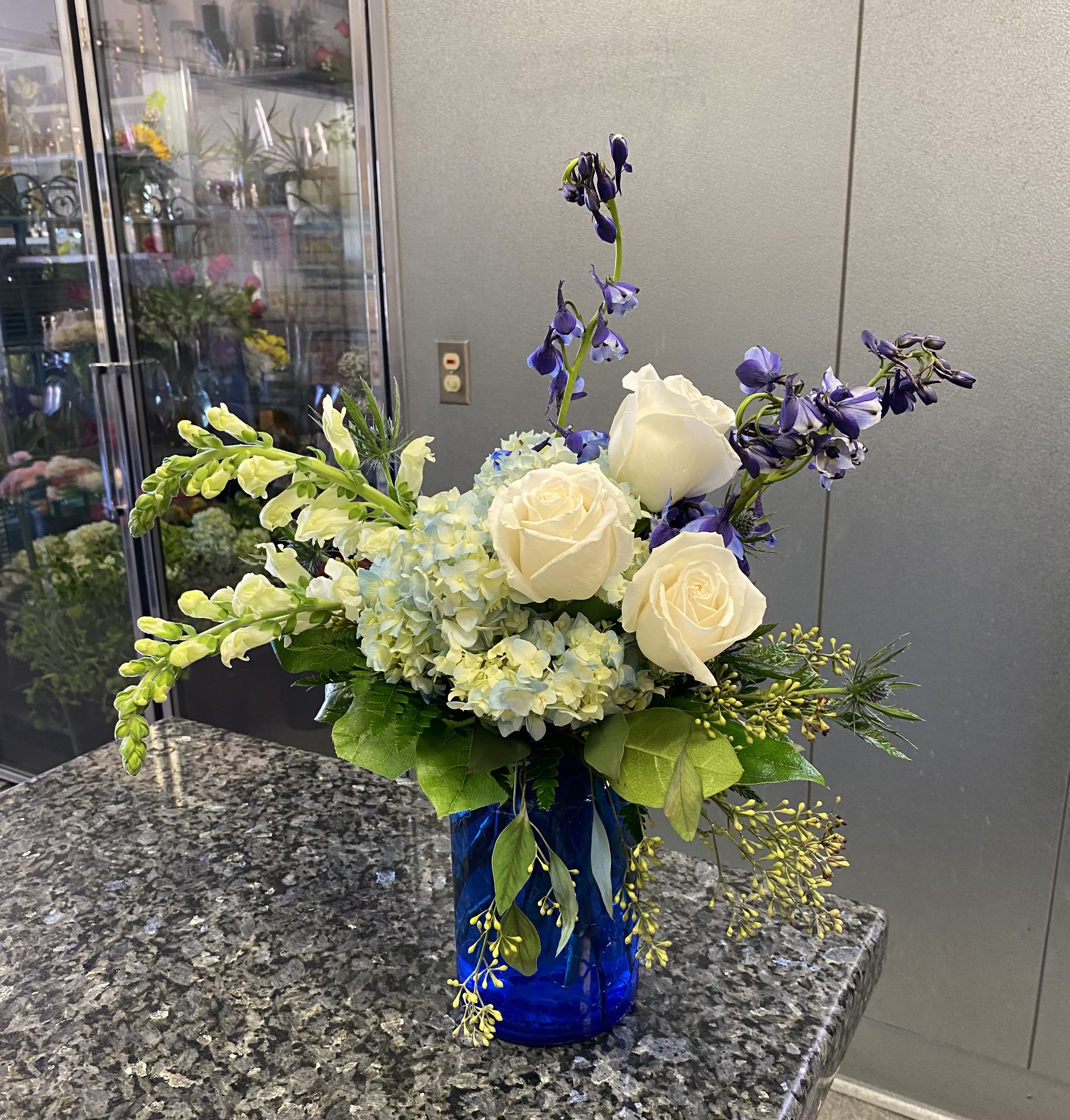 Ocean Breeze - Blue and White Flowers in a Blue Glass Vase. 