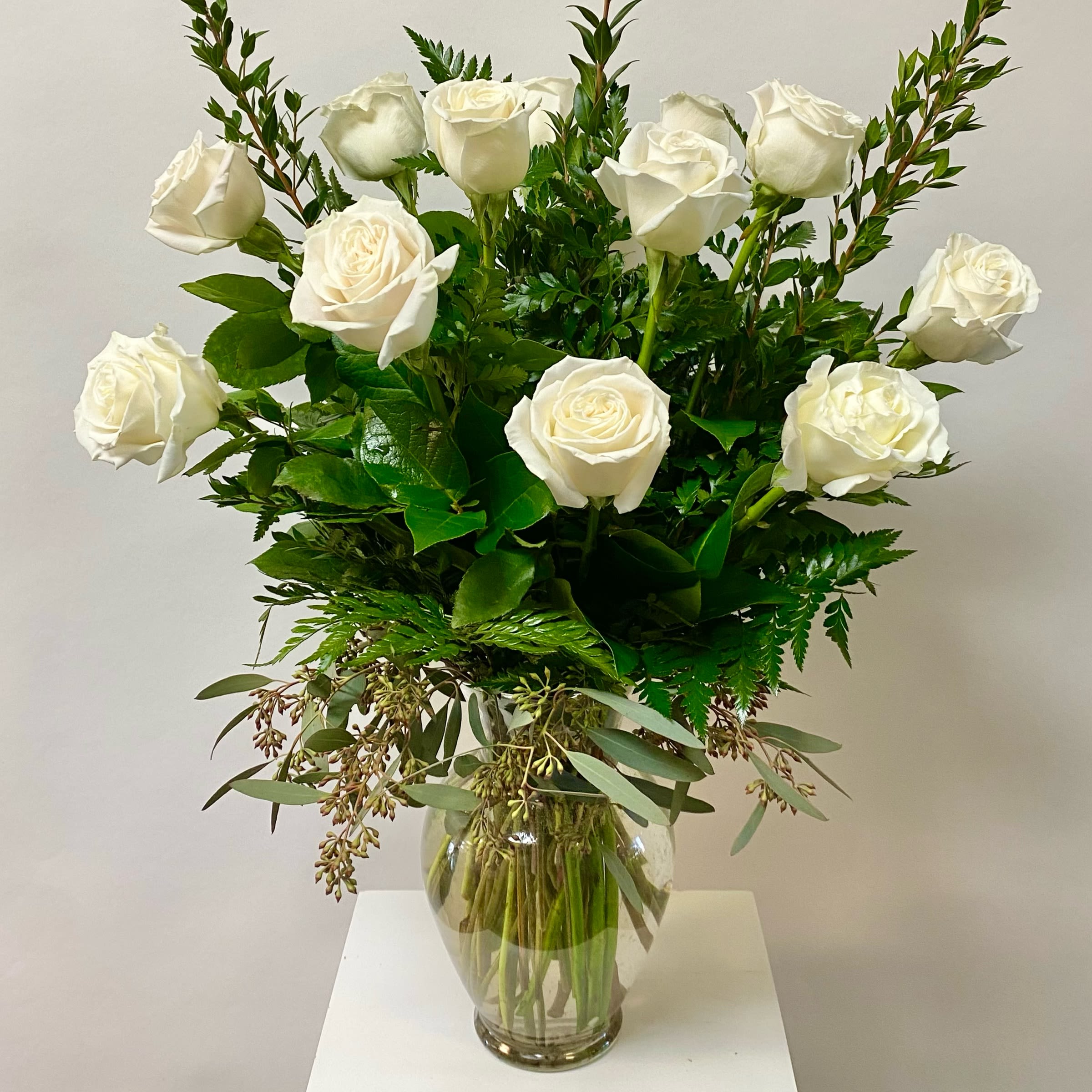 Dozen White Roses - White Roses with Greenery Arranged in a Glass Vase. 