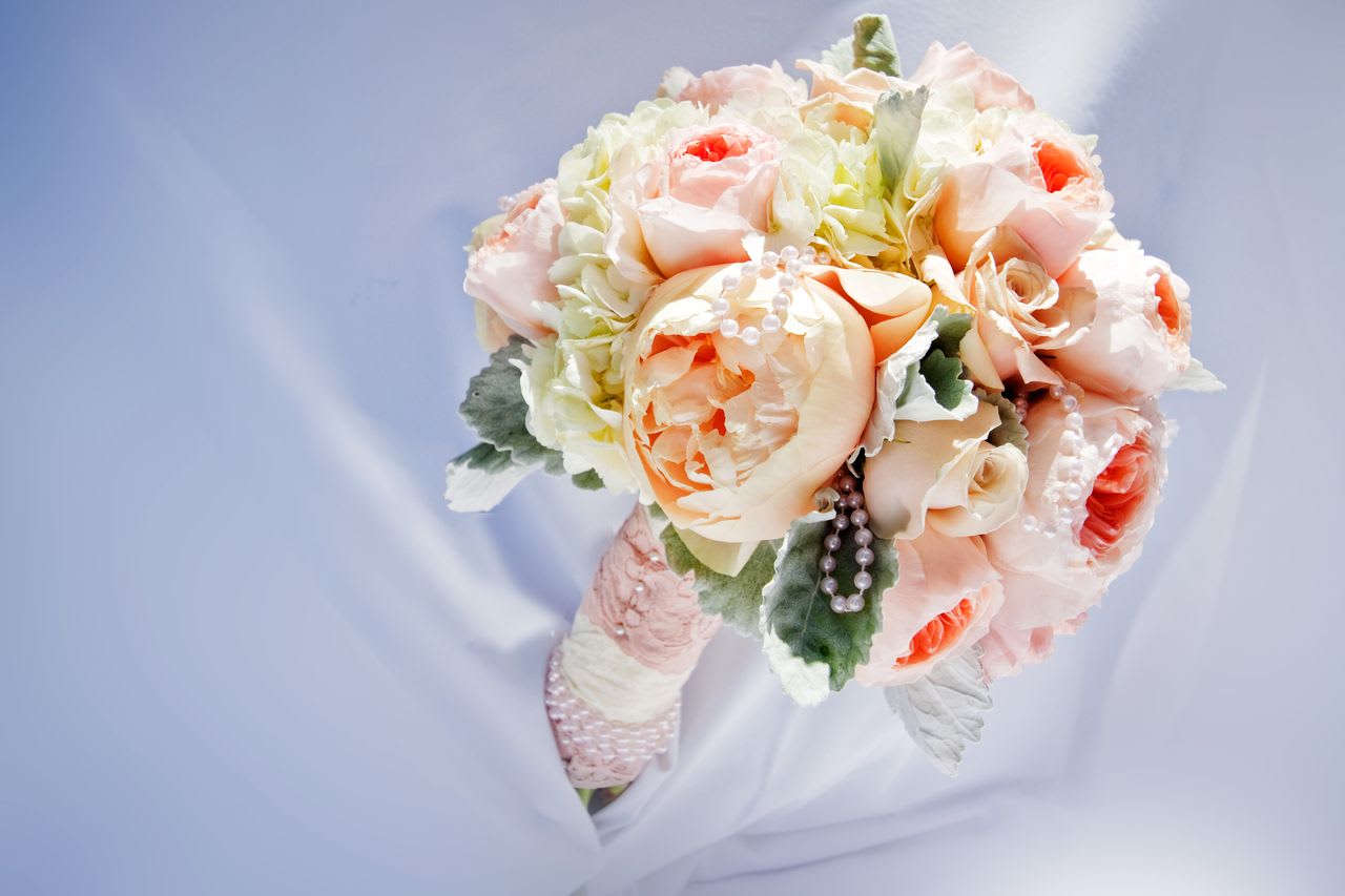 Peach Garden Rose and Peonies Bridal Bouquet - Peach garden roses, peach peonies, peach roses, white hydrangea, dusty miller. Hand tied and accented with lace and pearls. 