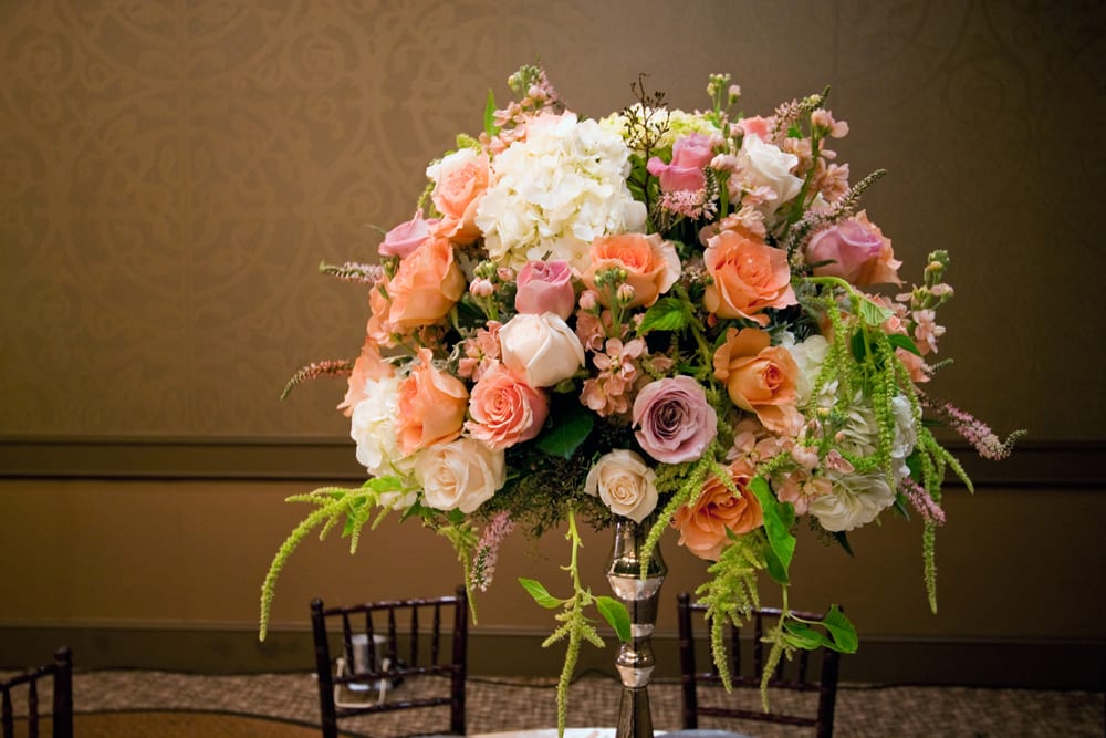 Traditional Centerpiece - A full and lush centerpiece placed on a tall silver stand. Please note the stand is a rental. 