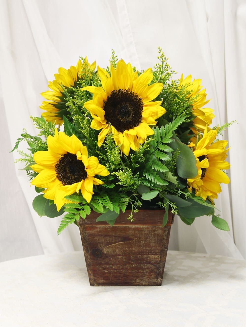 Box of Sunflowers - A lively bunch of sunshine and pep in a picturesque planter.  Key notes for this design are sunflowers and a rustic opaque container.