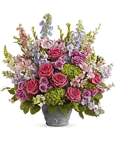 Keep Blooming Keep Blooming - Honor any important occasion with this grand bouquet of gorgeous pink, lavender and blue blooms, artfully arranged in a classic, Parisian-inspired pot. This arrangement features green hydrangea, hot pink roses, lavender spray roses, light pink alstroemeria, light blue hybrid delphinium, pink larkspur, white snapdragons, lavender stock, myrtle and lemon leaf. Orientation: One-Sided