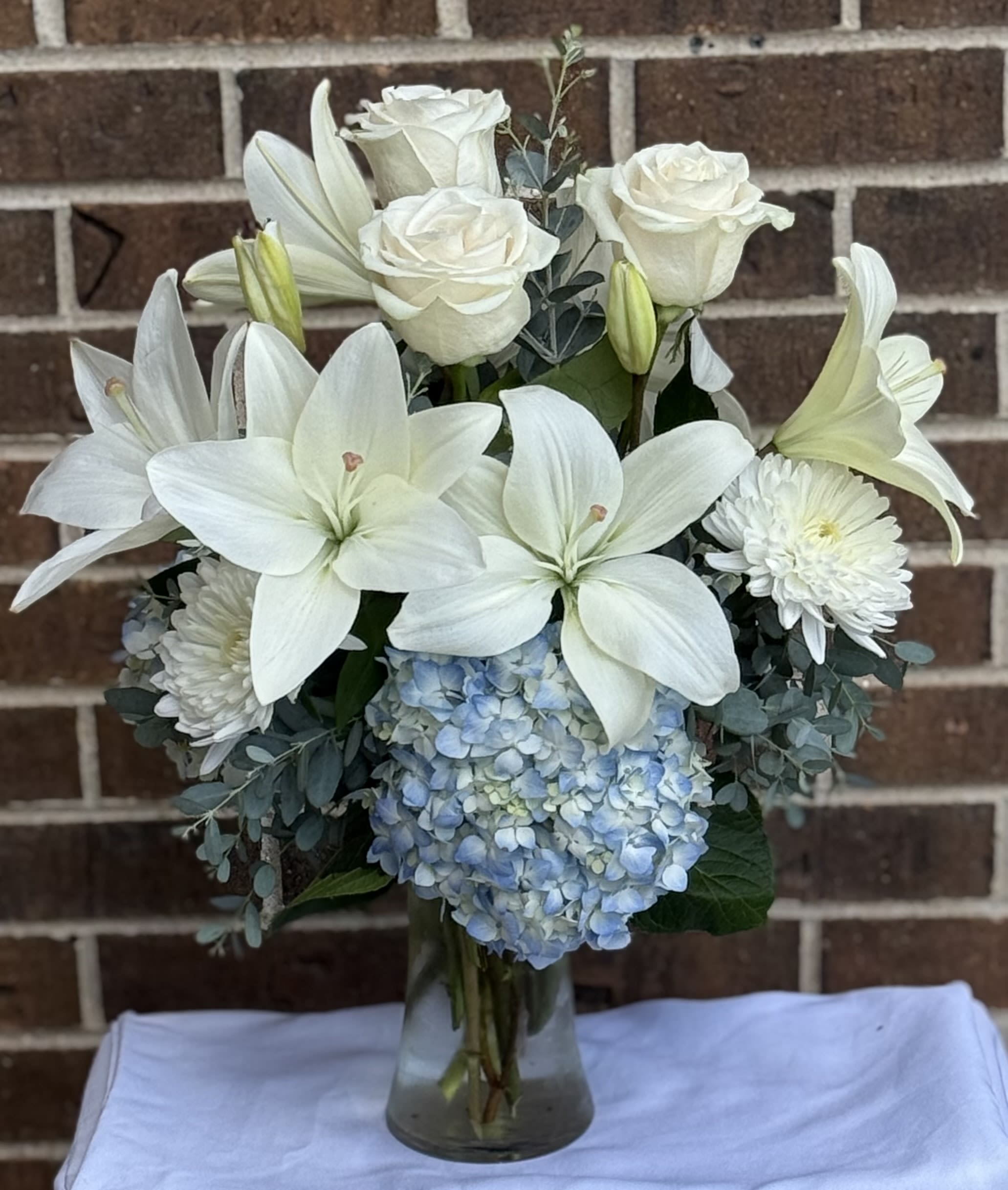 Classy and Traditional  - Lilies, Hydrangeas, roses, eucalyptus, Cremon and foliage 
