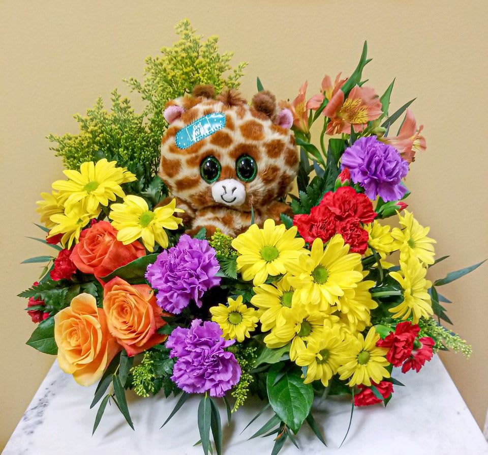  Boo Boo Buddy- Get Better soon Bouquet - They're sure to get well &quot;beary&quot; soon with this hand-delivered, thoughtful surprise of fresh mixed flowers and sweet snuggles from this charming bear plush bouquet! This cheerful arrangement includes orange roses, orange alstroemeria, red carnations, and yellow daisy spray chrysanthemums, accented with yellow solidago, variegated pittosporum, spiral eucalyptus, huckleberry and lemon leaf. Delivered with a Boo Boo Buddy plush keepsake. Approximately 16&quot; W x 16L Plush animal will vary depending on availability, will be Giraffe, Monkey, elephant or Dog