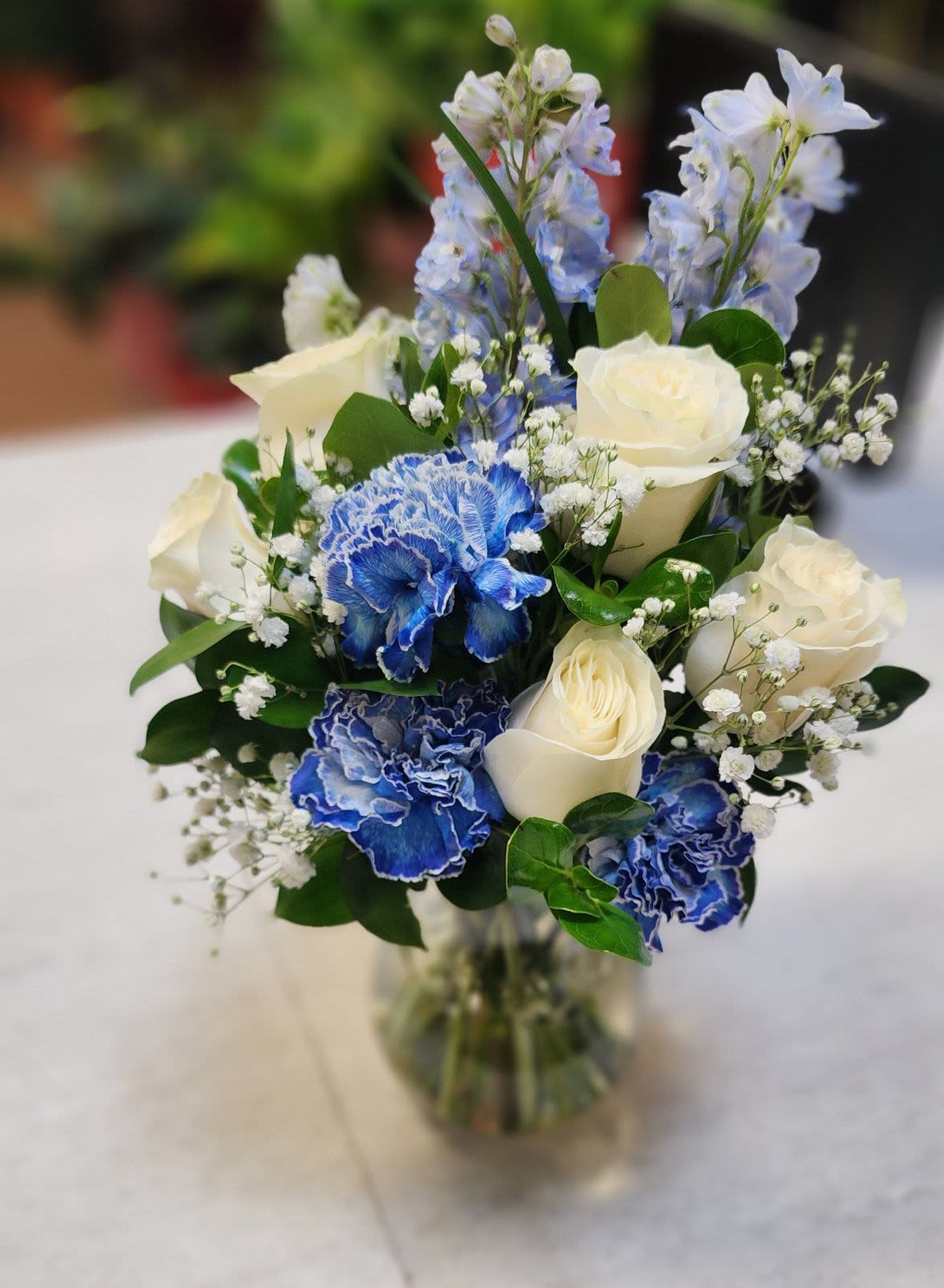 Icy Elegance - White Roses, blue carnations, blue delphinium in a vase